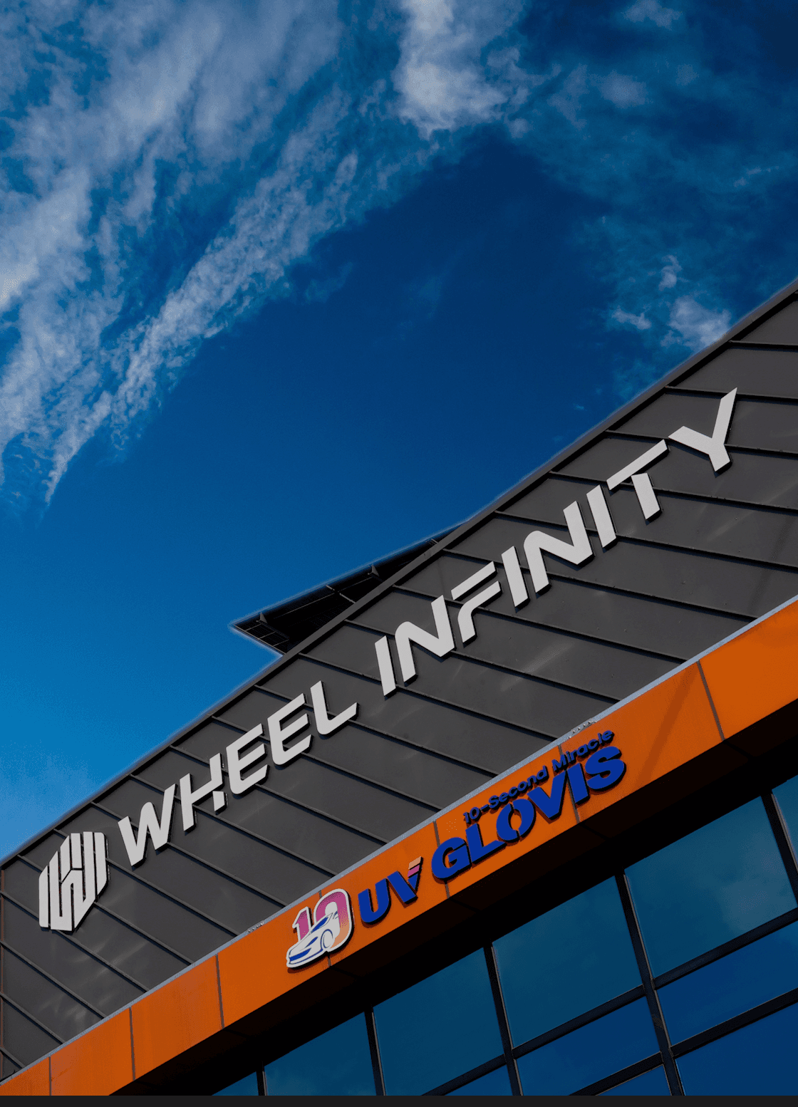 Modern indoor space with large glass doors, lush greenery, and a cozy seating area visible beyond.