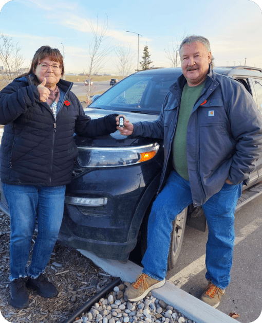 happy ford owners holding new car key made by carkeyaction