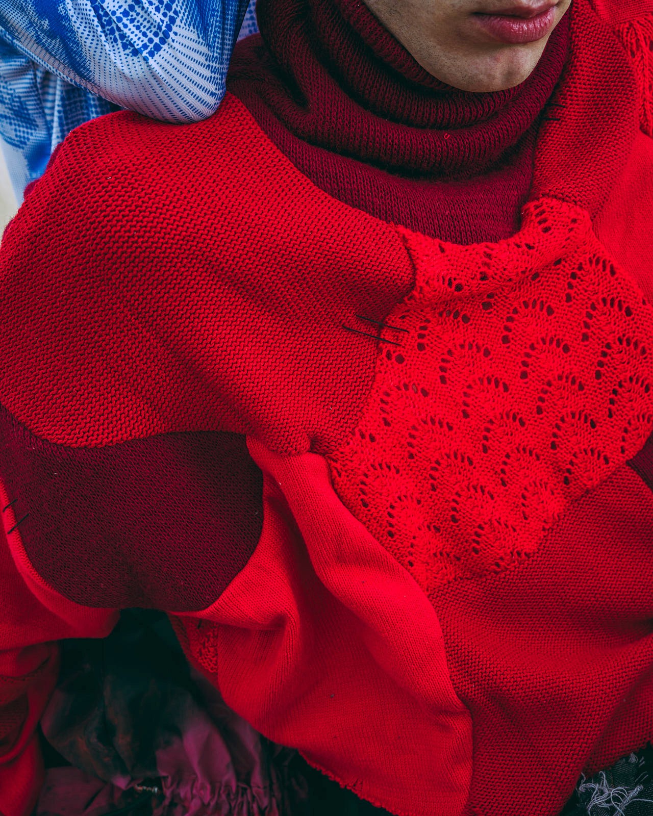 Close-up of a yellow tennis ball sitting on a green court, positioned near the white center line.