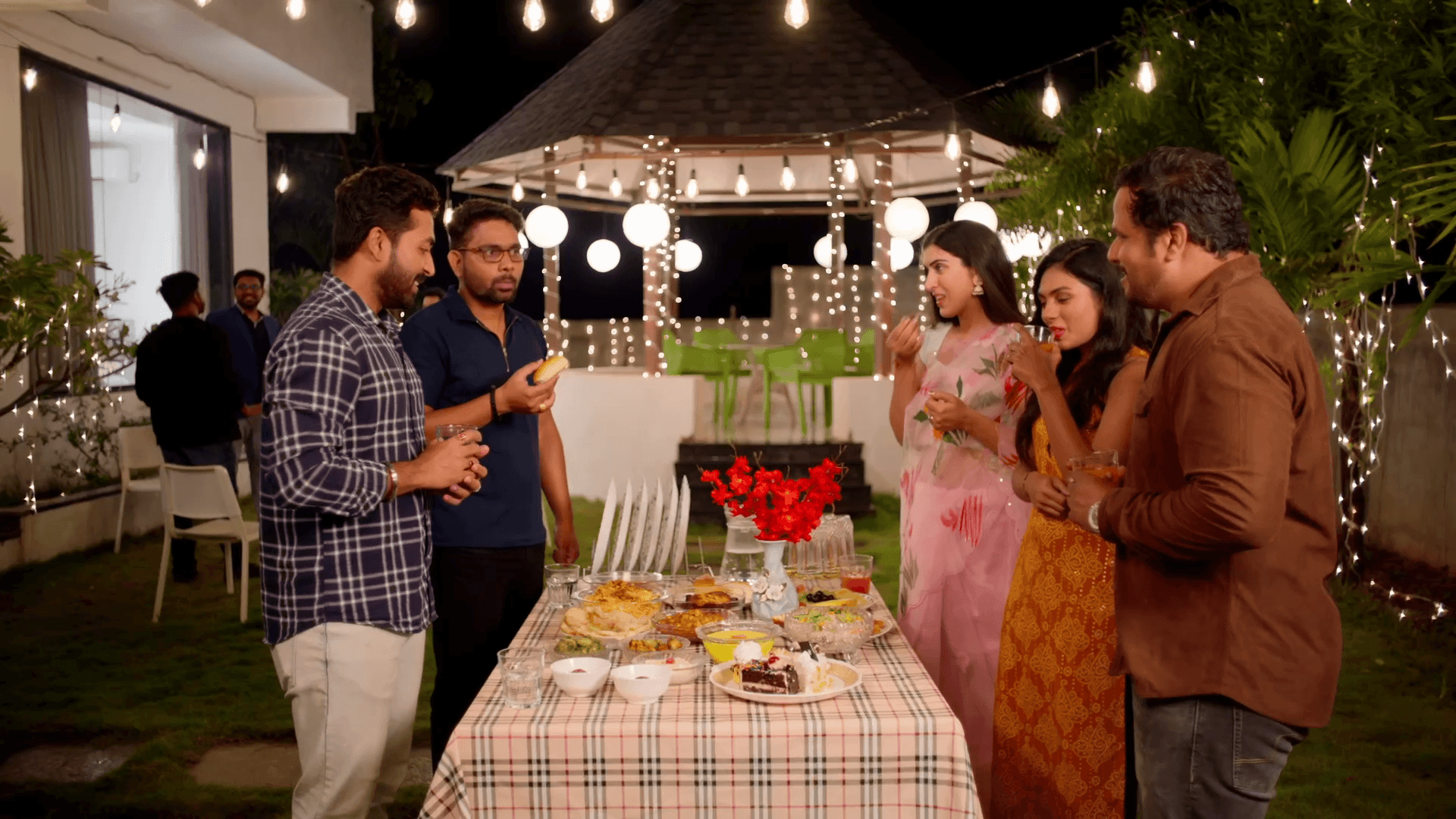 Group of friends gathered around a dinner table in the Hungersate ad film.