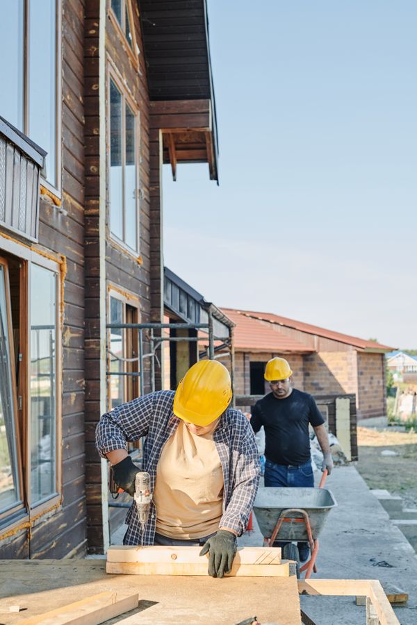Builders working on a timber house frame
