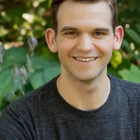 Colton Fyfe headshot in front of plants