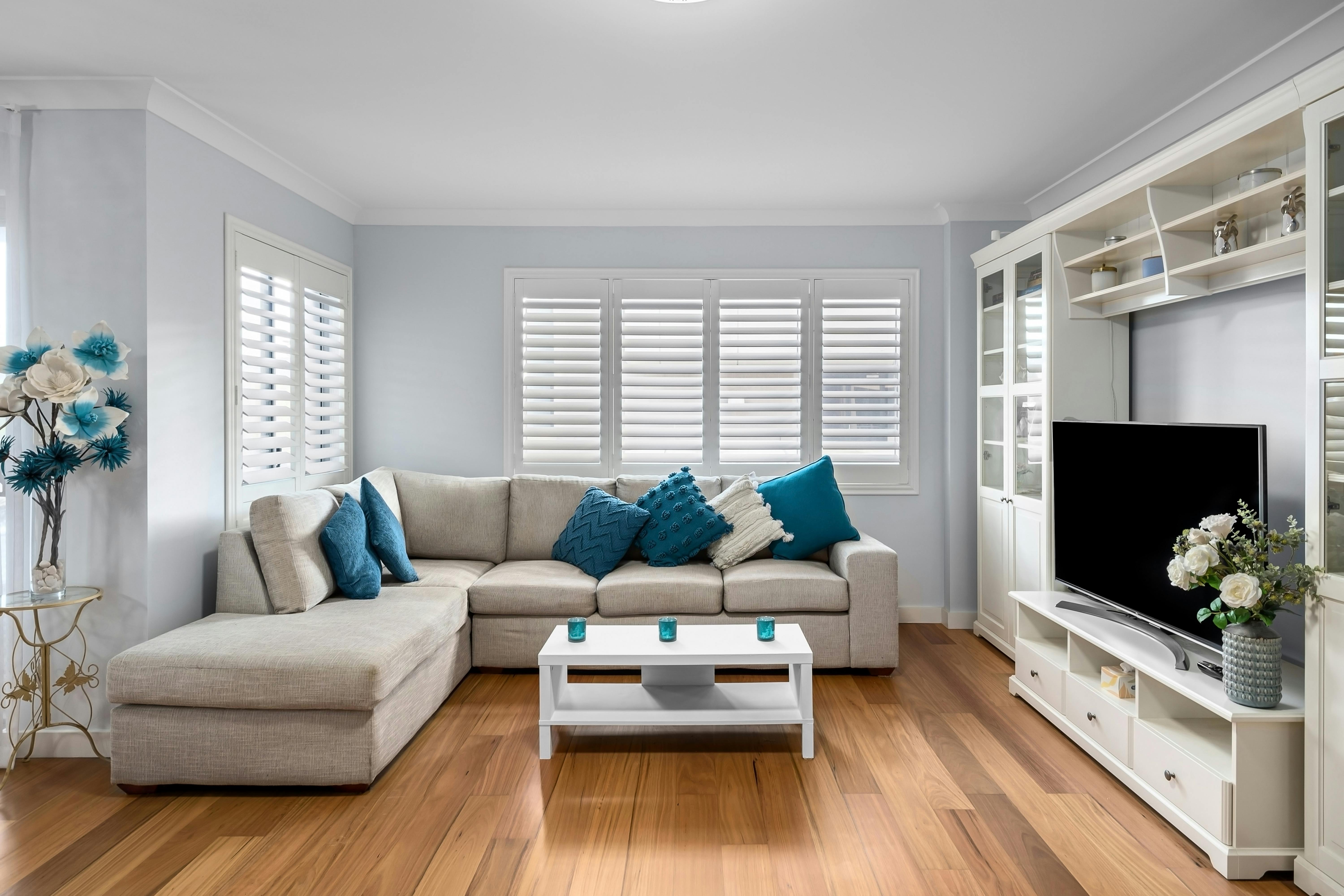Bright living room with couch and timber floors