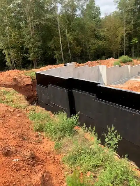 Rub-R-Board drainage board on the exterior of a new home foundation to protect the waterproofing membrane