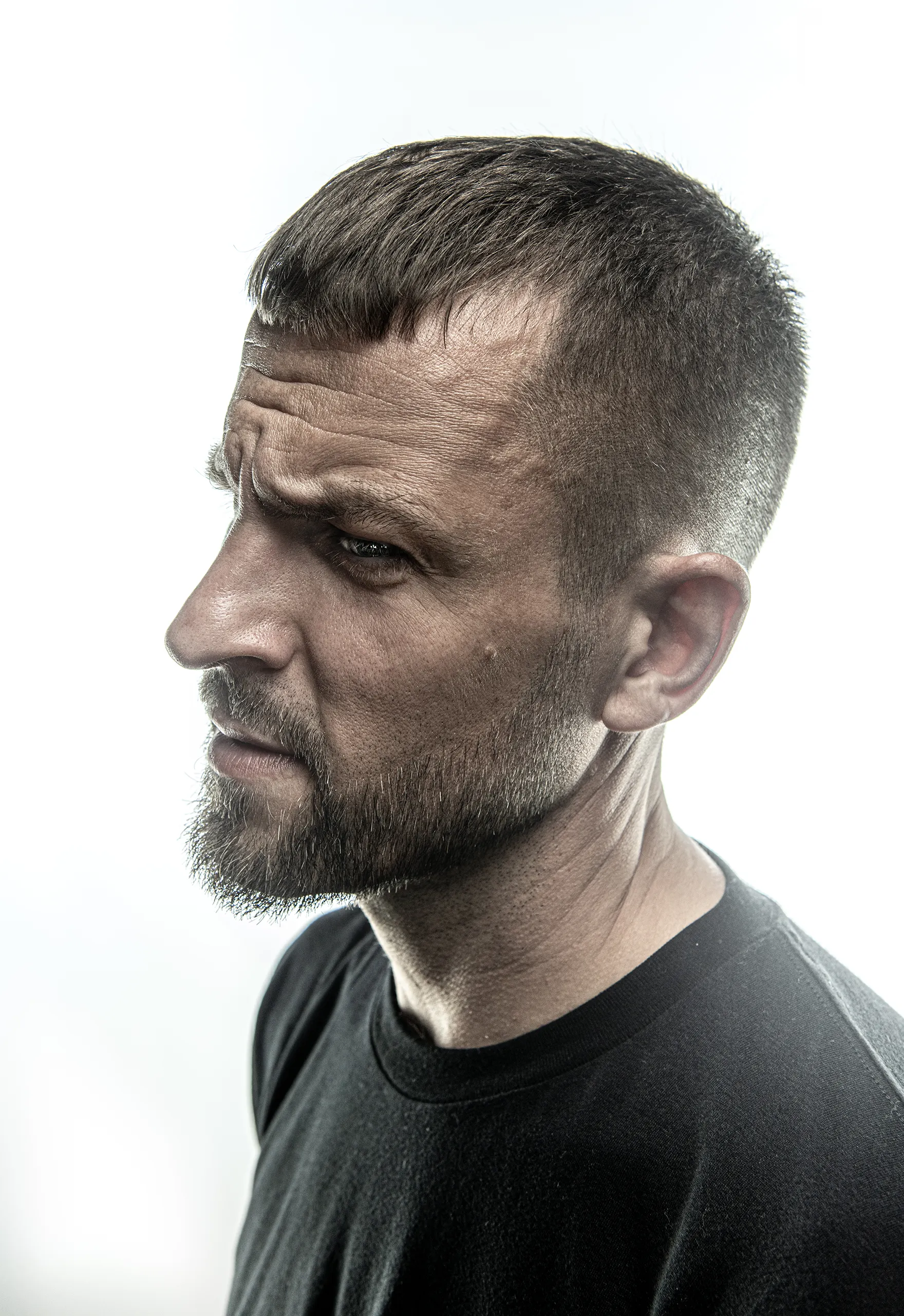 A high contrast side profile portrait of Stress in black and white.