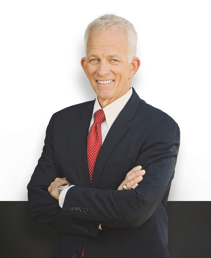 professional headshot man with light skin white hair dark suit, red tie, with arms crossed in confident pose, smiling 