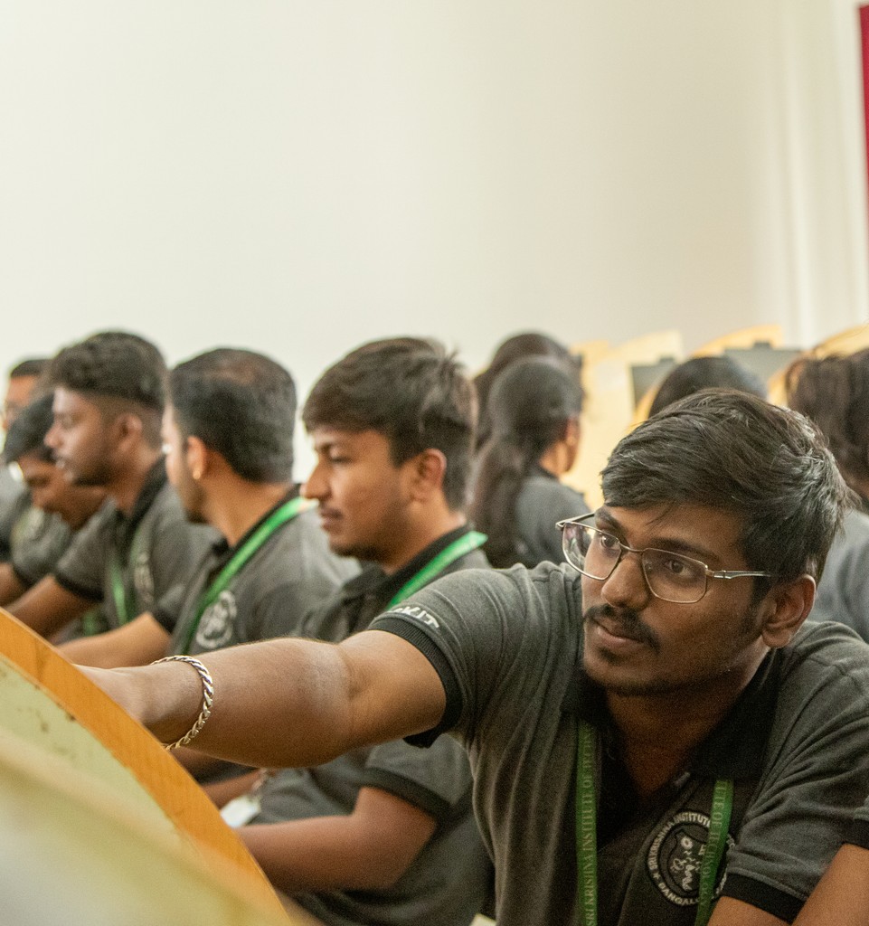 woman in black shirt holding green and blue plastic toy