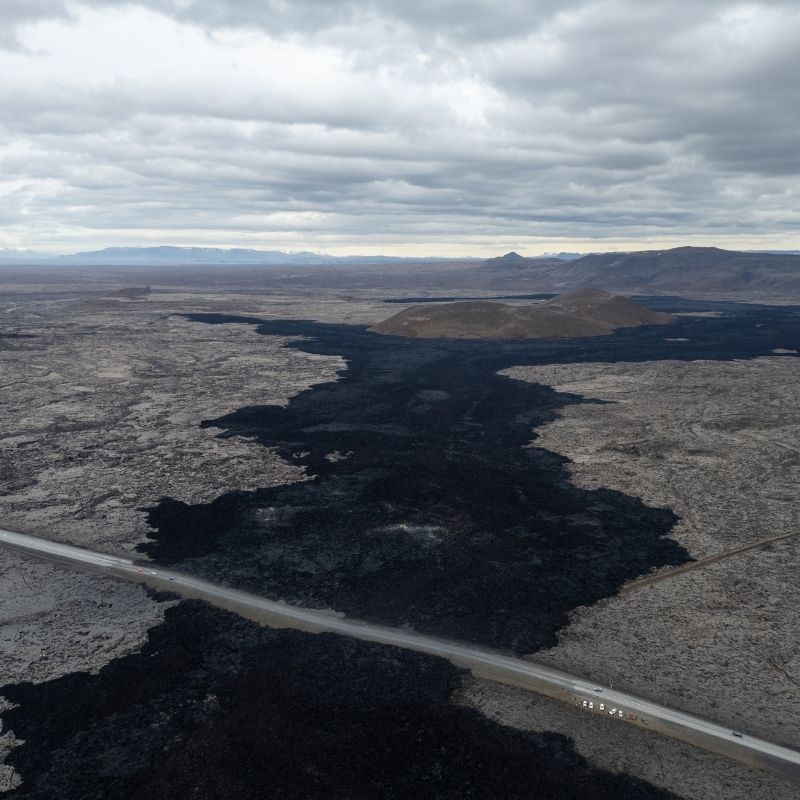 Fresh black lava stretching across the Reykjanes Peninsula in Iceland, showcasing newly solidified volcanic rock created during the recent eruptions that reshaped the region's landscape.