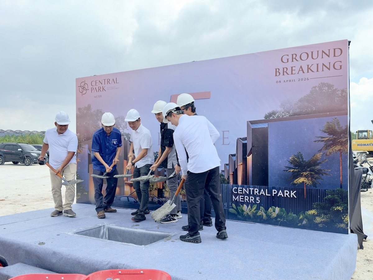 Family picking apples from a tree in an orchard.