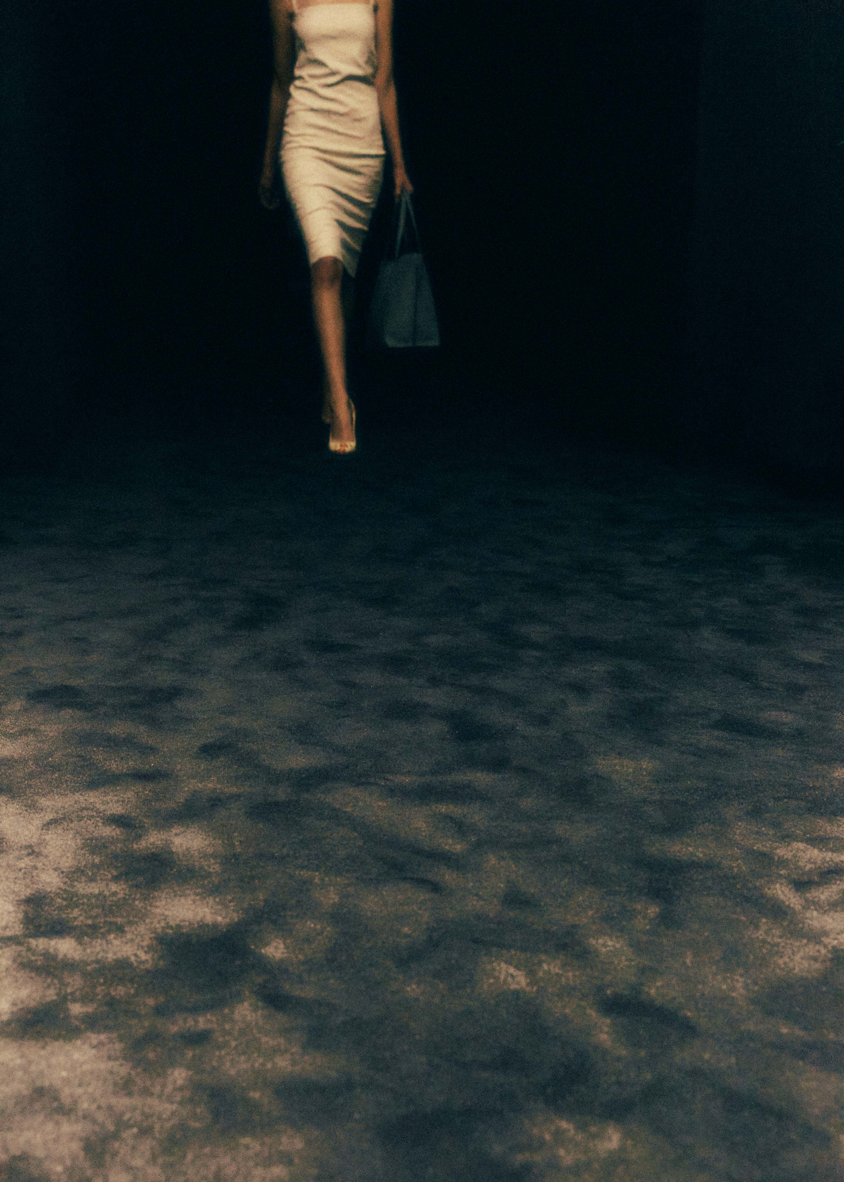 A fast black sports car races down the highway.