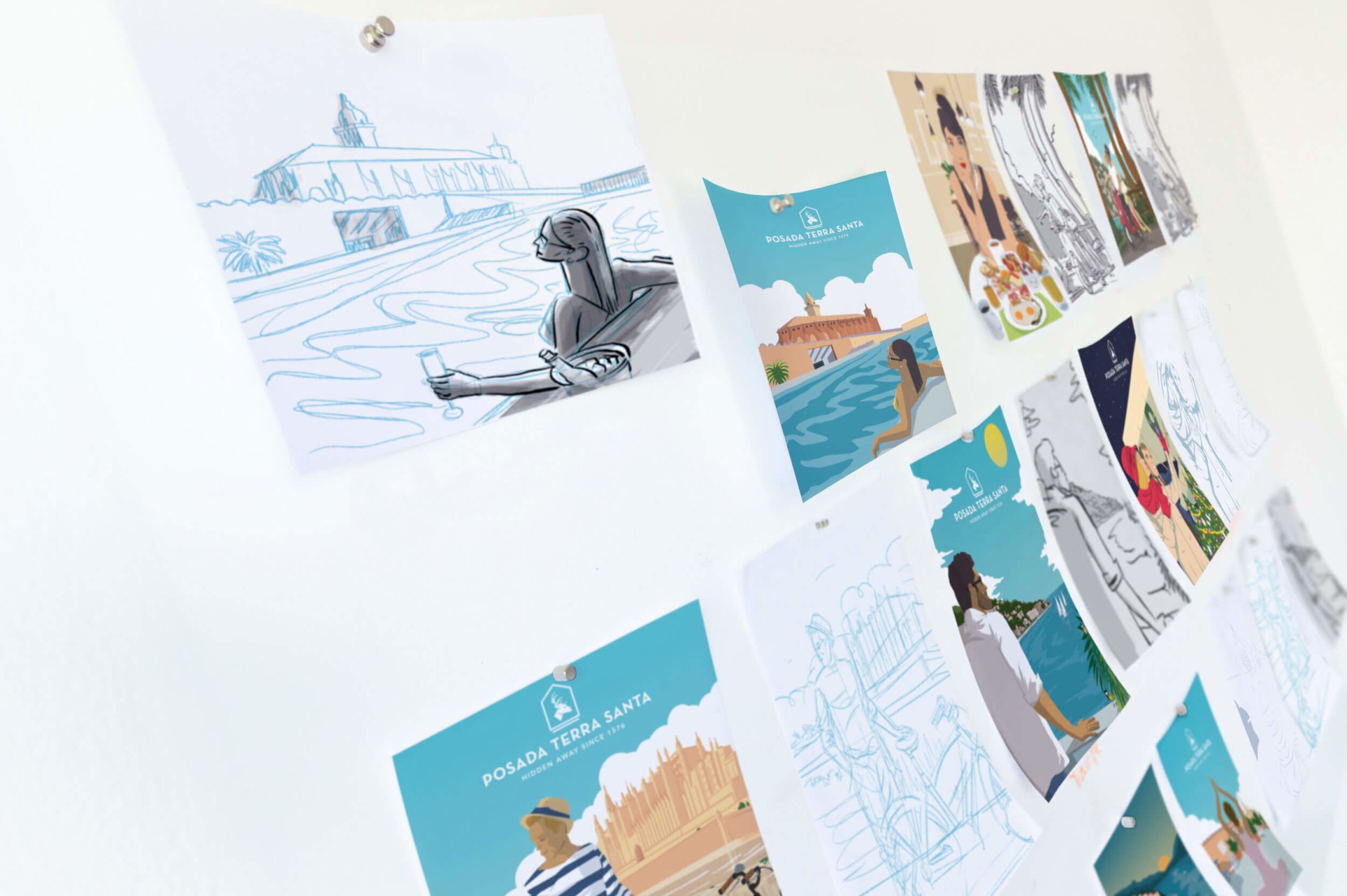 Ilustraciones y fotografías de Posada Terra Santa en una pared blanca.