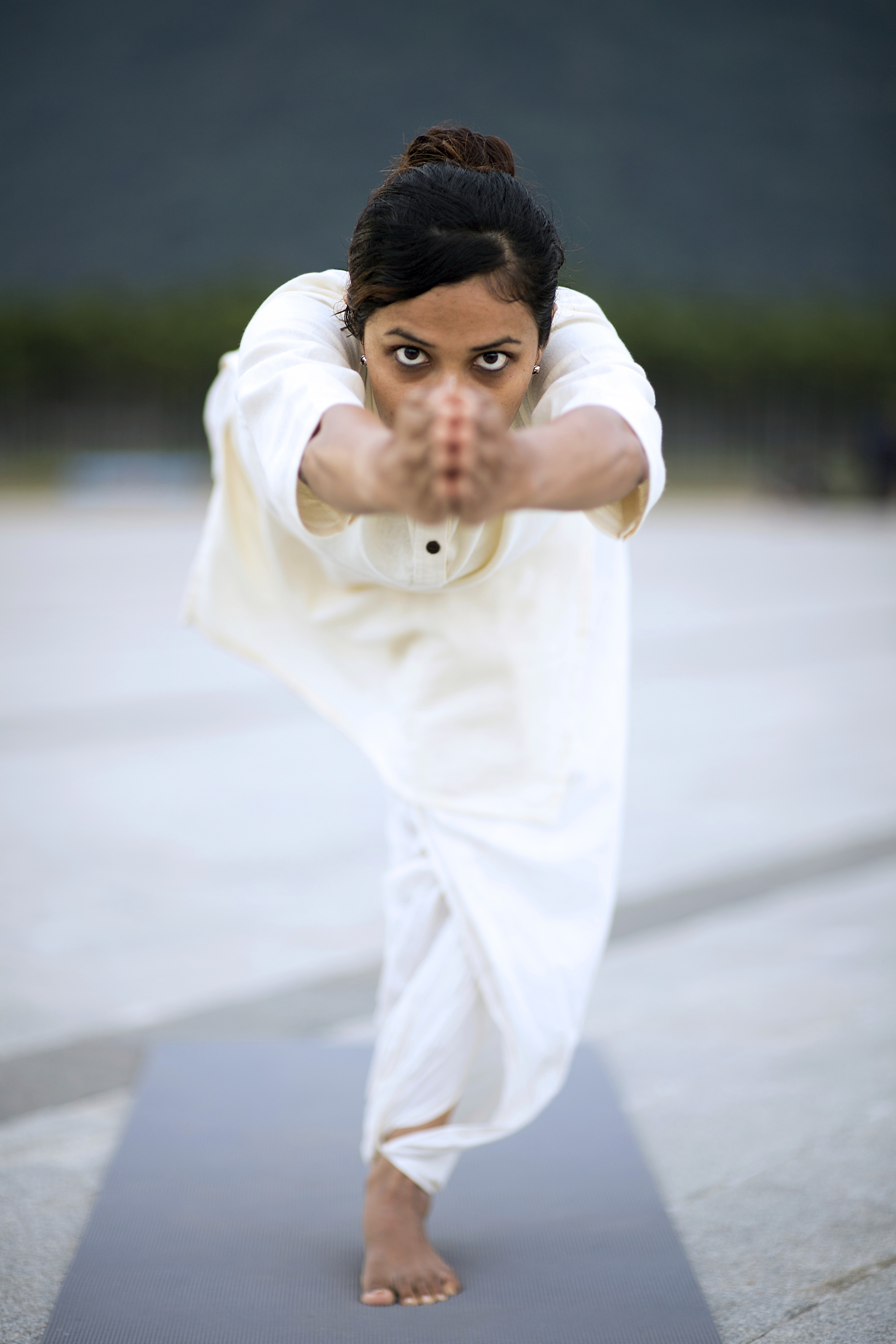 A woman in a straw hat stands in the grass
