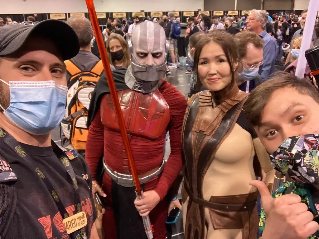 Jared and Freddie pose at Star Wars Celebration alongside cosplayers dressed as Darth Malak and Bastila Shan from Knights of the Old Republic. The group stands together, embodying the classic KOTOR characters in stunning detail