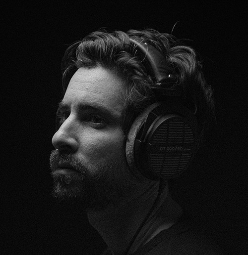 Profile portrait of a man in a grey shirt