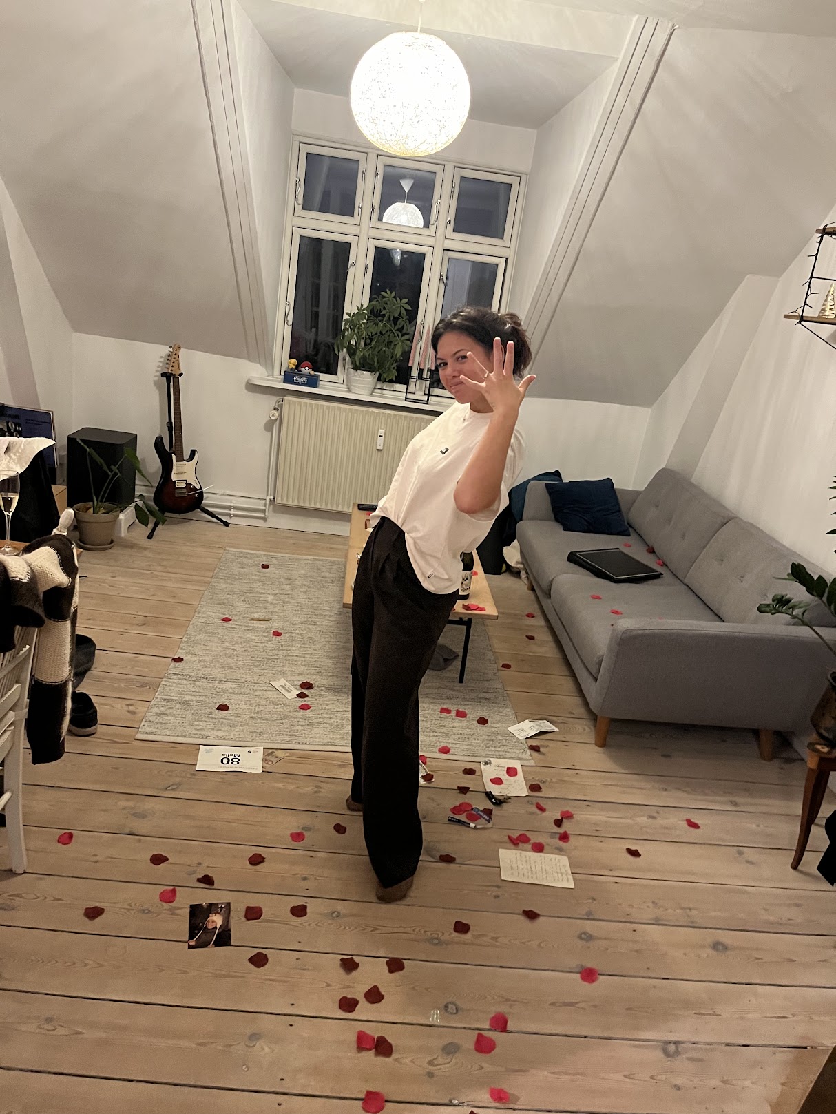 A serene outdoor wedding setup with white chairs arranged on green grass under a canopy of trees.