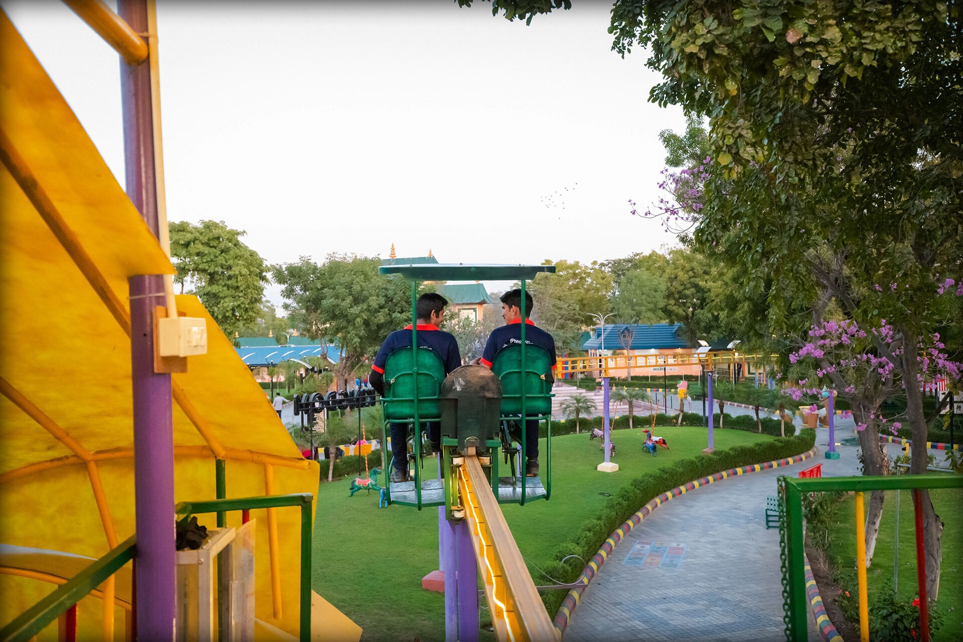 Sunlit minimalist hallway with staircase, wooden bench, plants.