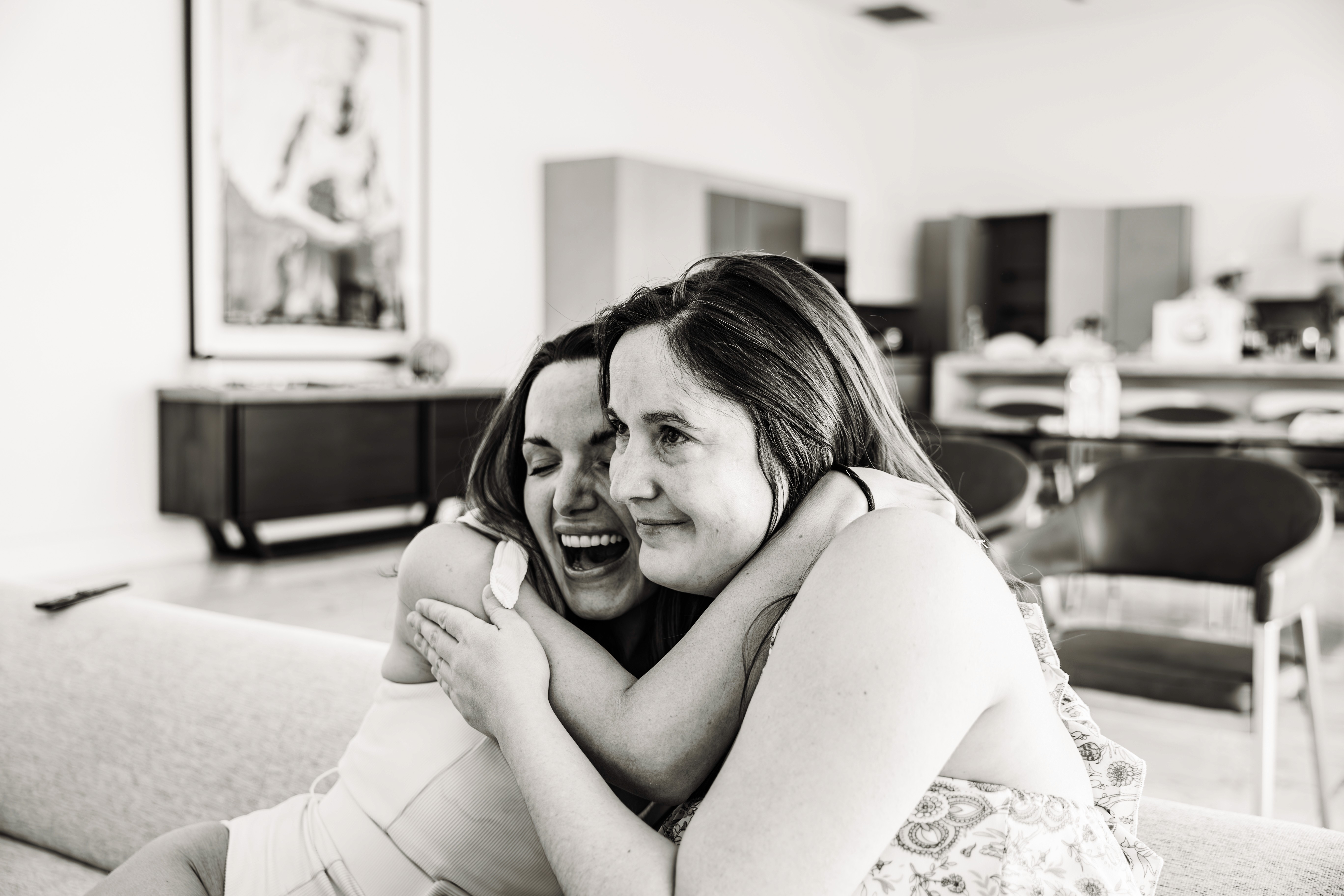 Sisters wrapped in a warm embrace during a sun-soaked bachelorette vacation weekend in Palm Springs — candid, joyful destination bachelorette photography by Lizz Spano Photography, Palm Springs vacation and destination photographer.