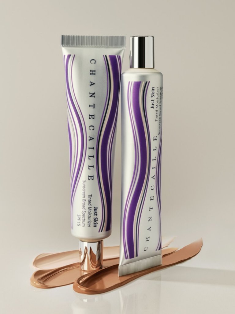 Two Chantecaille skincare products, a tube and a bottle, positioned against a neutral background with swatches of tinted moisturizer in shades of brown.