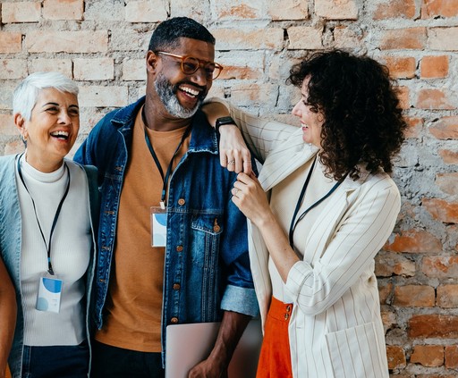 Diverse colleagues smiling and networking in office