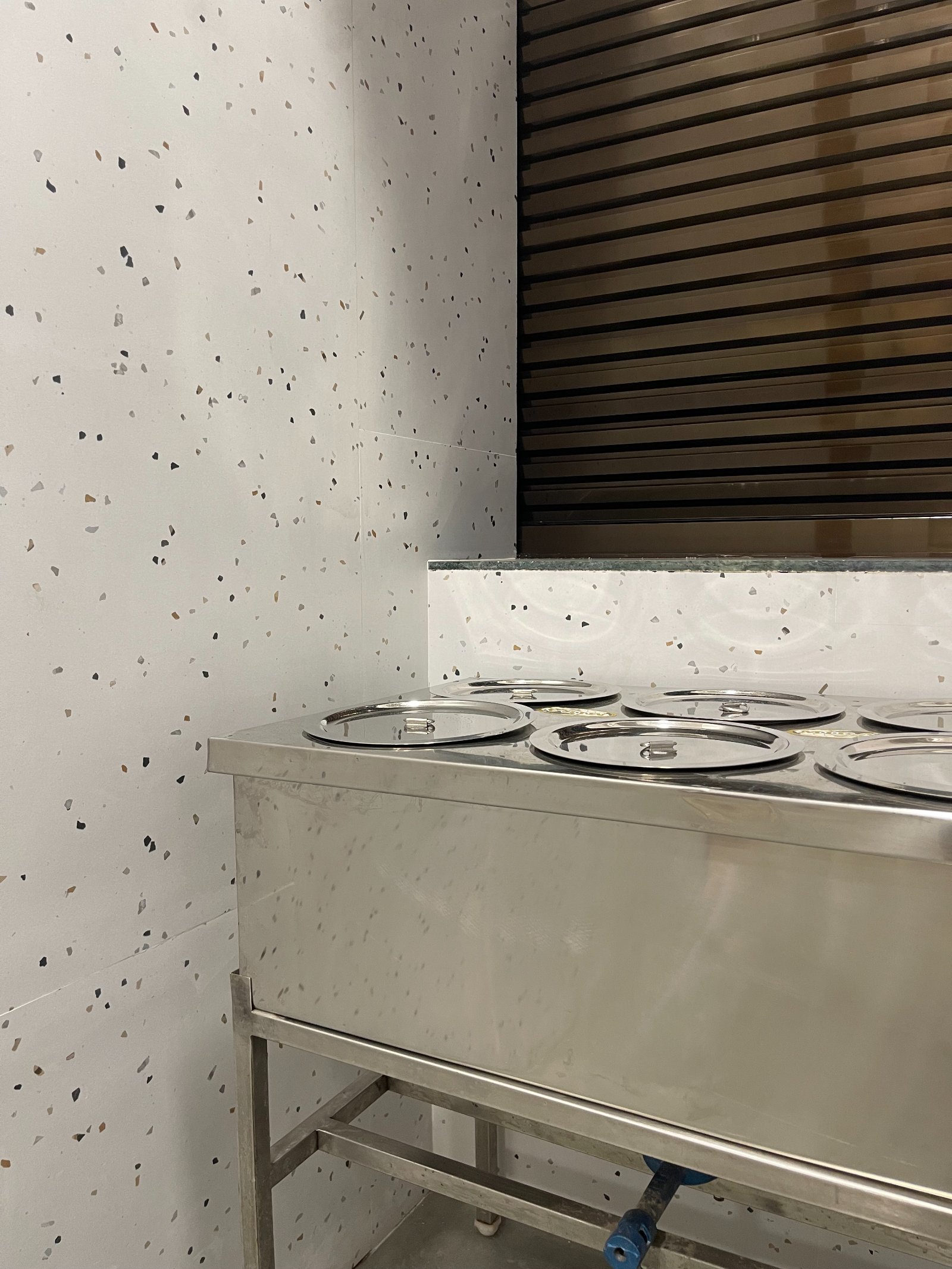 Nature-inspired preschool entrance with sculptural tree partitions and suspended green leaf ceiling panels.