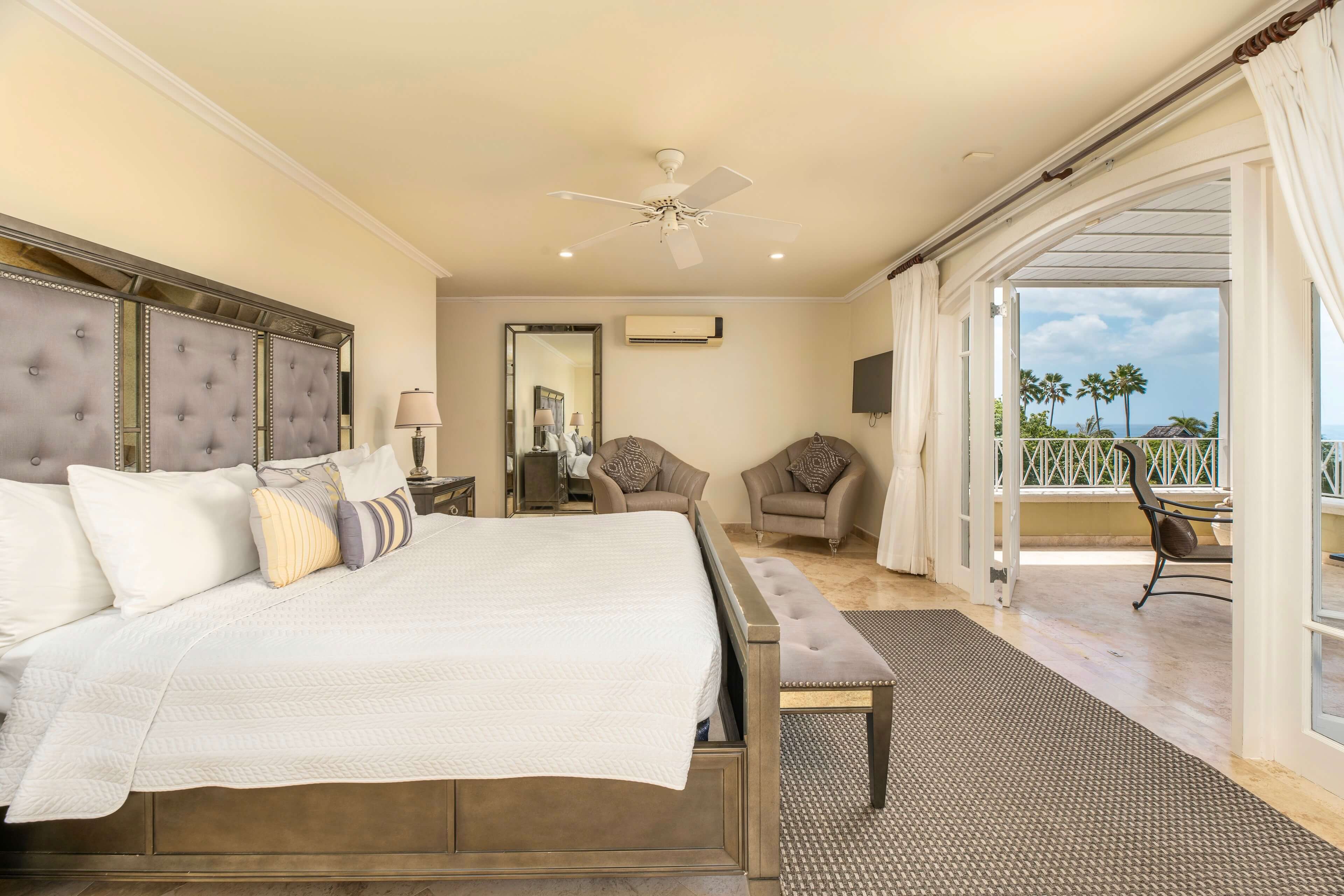 Cozy bedroom with balcony access and outdoor view