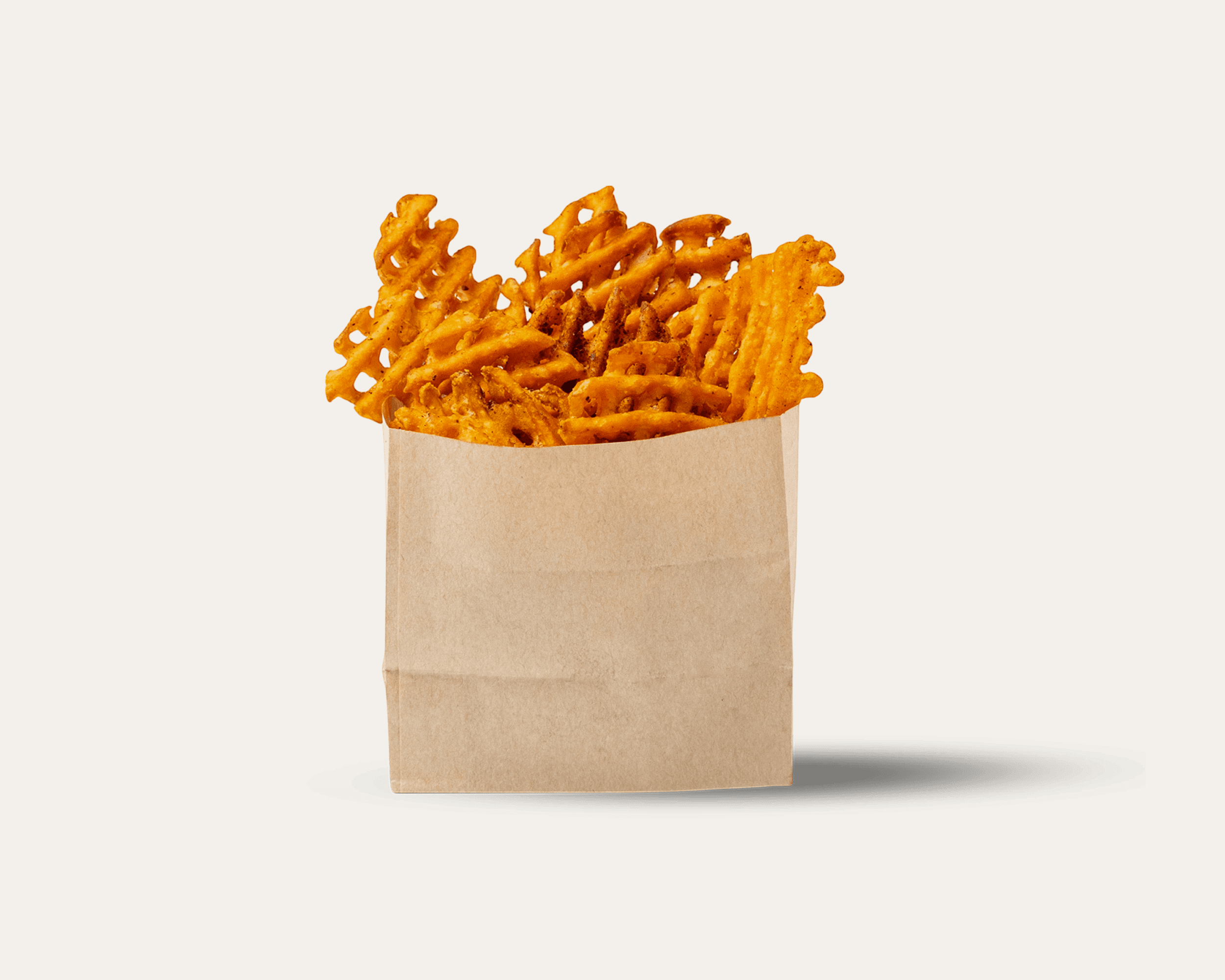 waffel cut sweet potato fries in a small paper bag