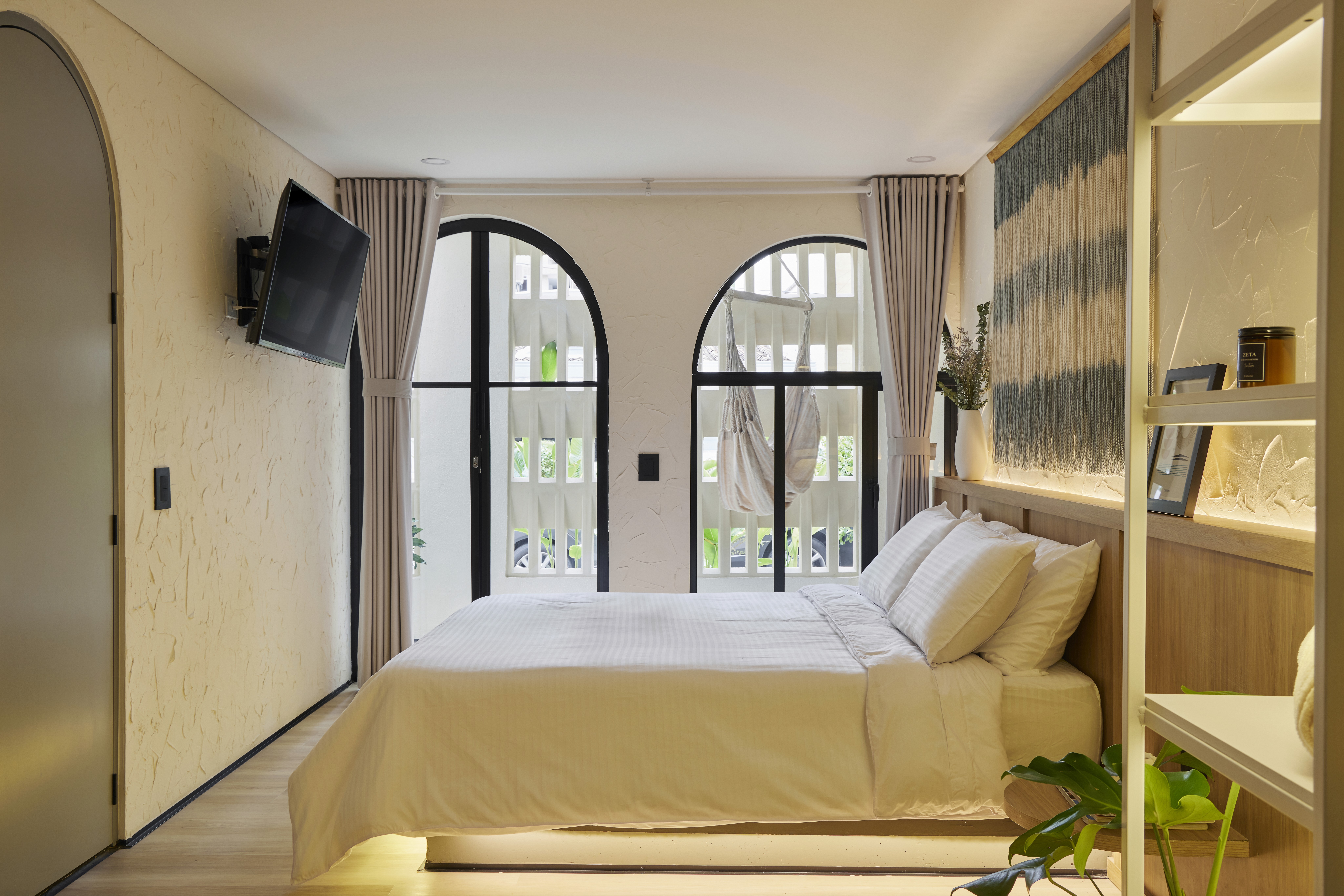 Double-height interior with flowing sculptural forms and warm raking light