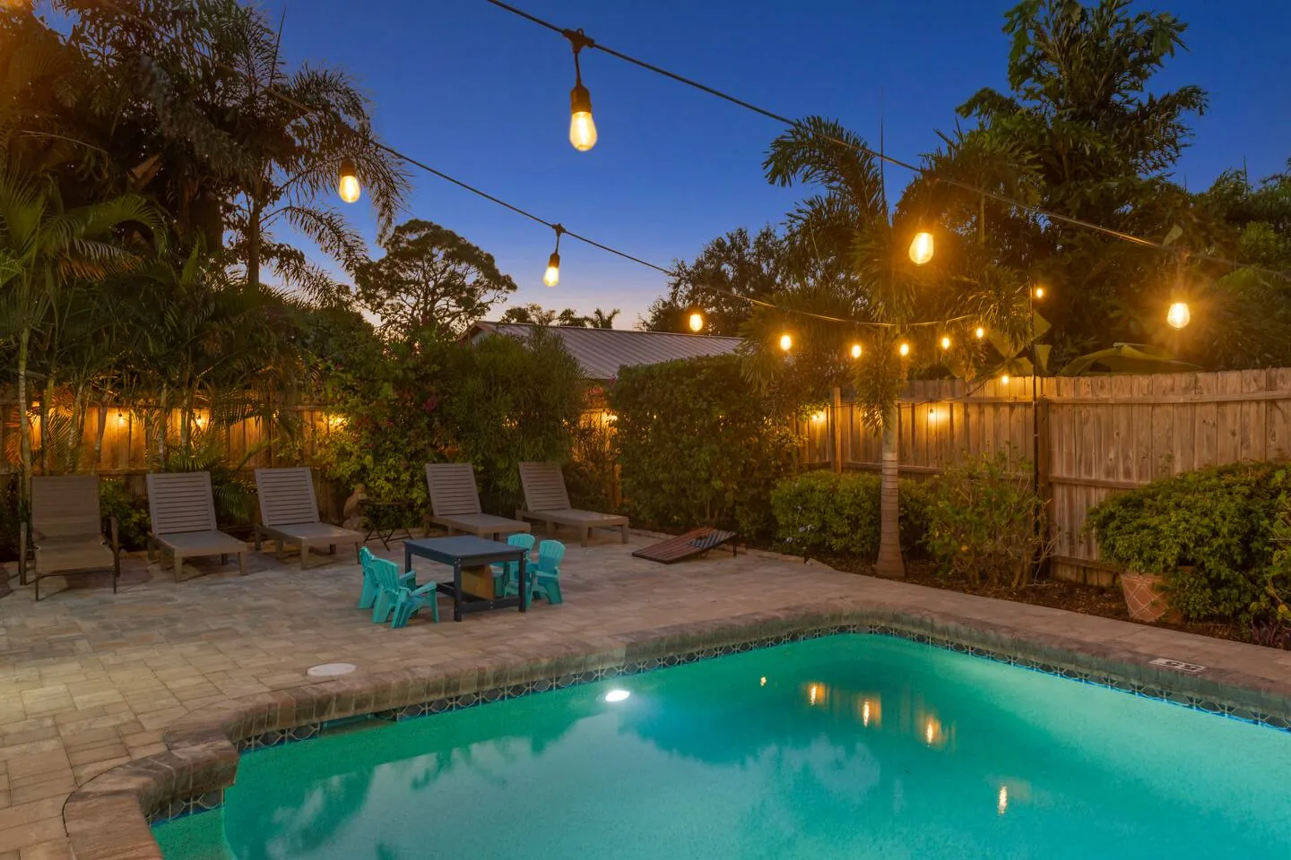 Pool at twilight under string lights at Sarasota Beach Bungalow, Bradenton, Florida