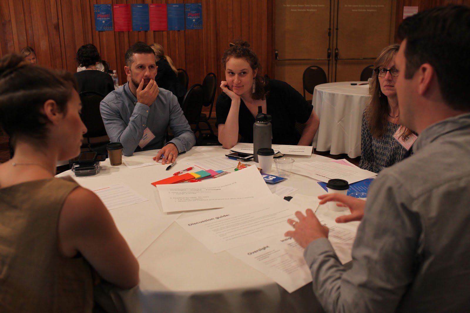 A group of six ILN attendees meet together around a table.