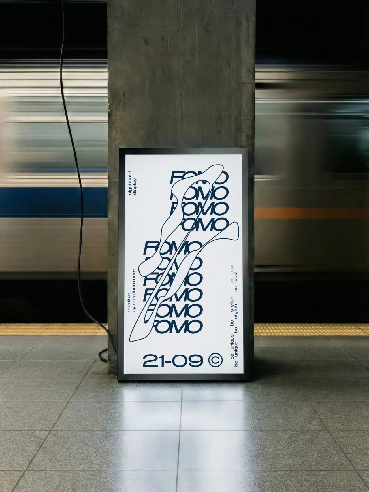 Framed typographic poster displayed against a concrete pillar in a subway station.