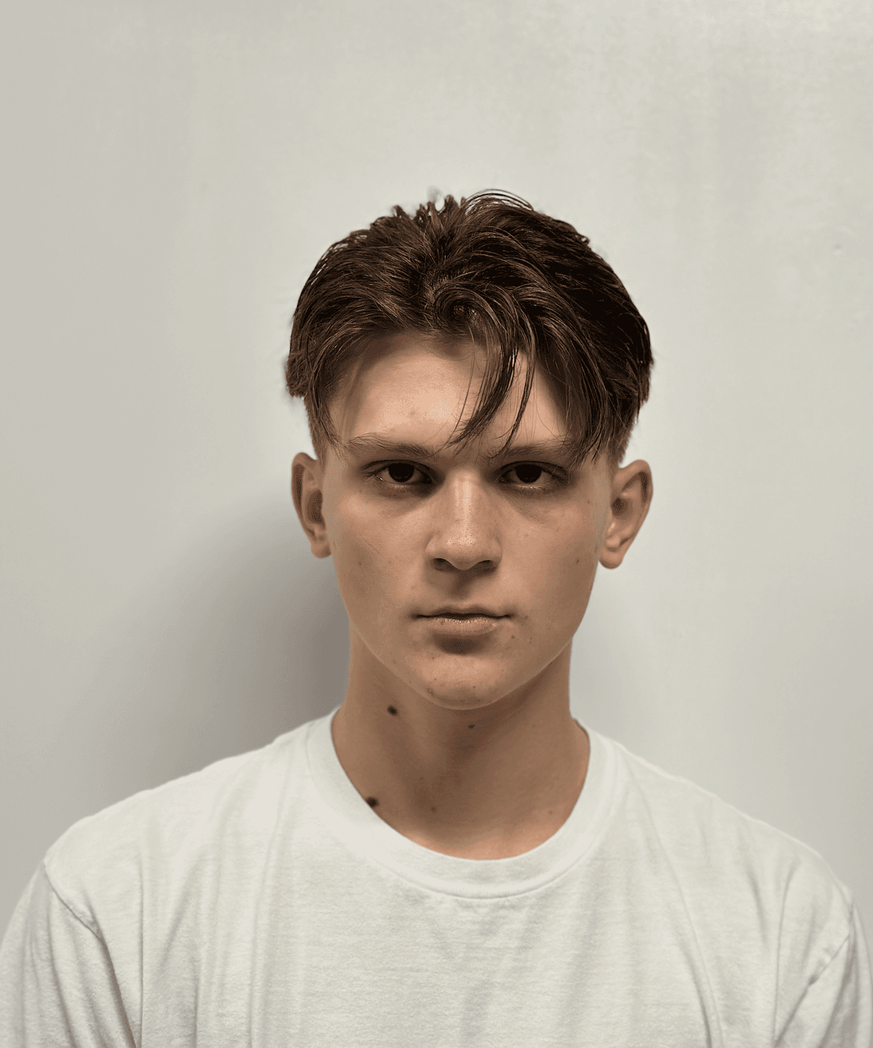 man standing near white wall