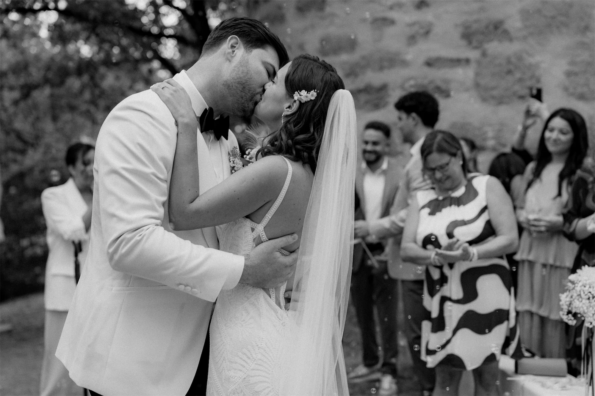 Cinematic black-and-white wedding photo of a piano during vows
