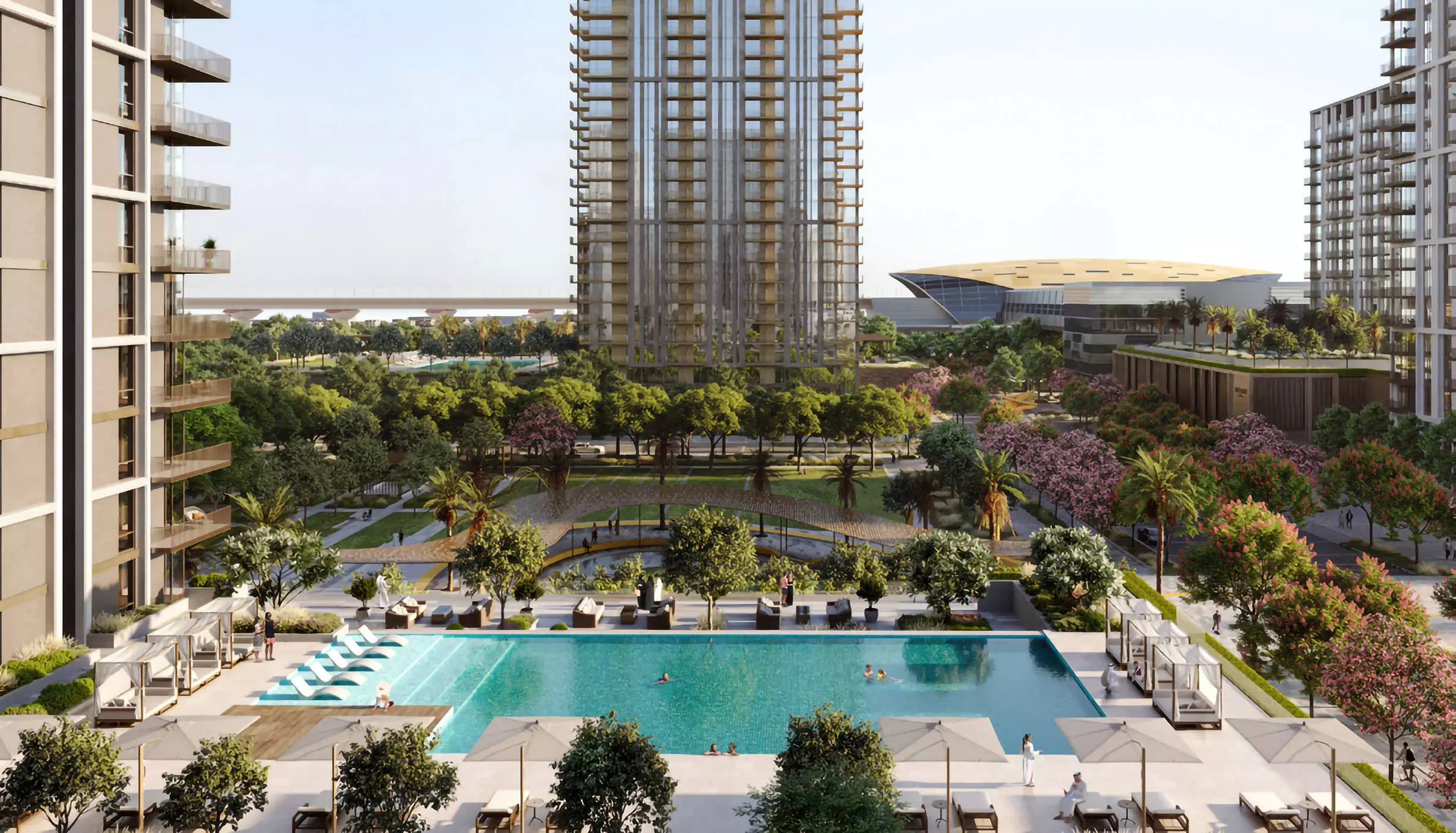 A large infinity pool surrounded by sun loungers and greenery at Aeon Dubai, offering serene views of landscaped gardens and high-rise buildings.