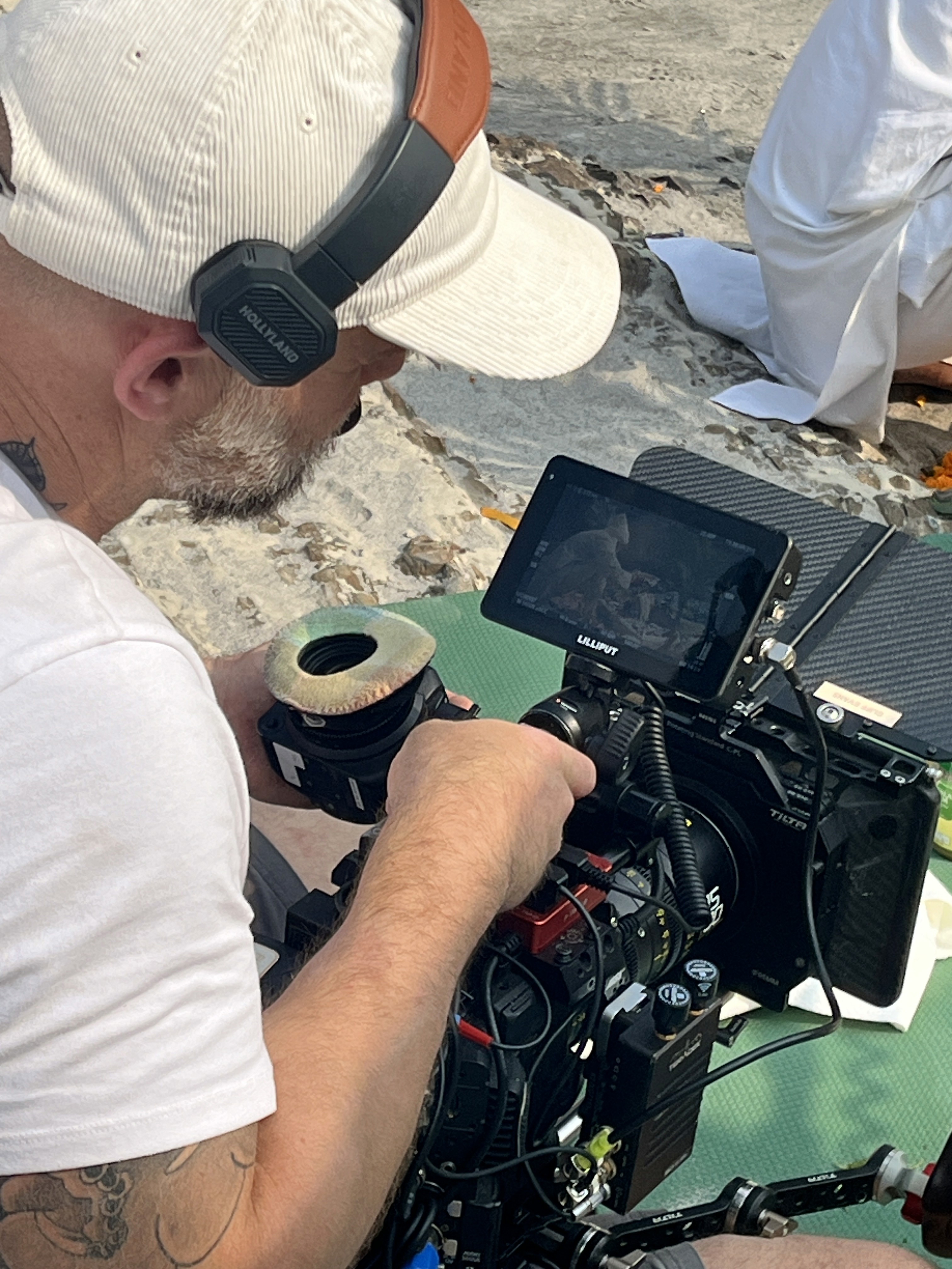 Modern table lamp with a black base and white shade casting a warm glow on a neutral background.