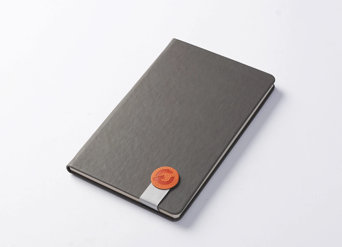 Premium executive notebook with secure magnetic strap and custom branding.