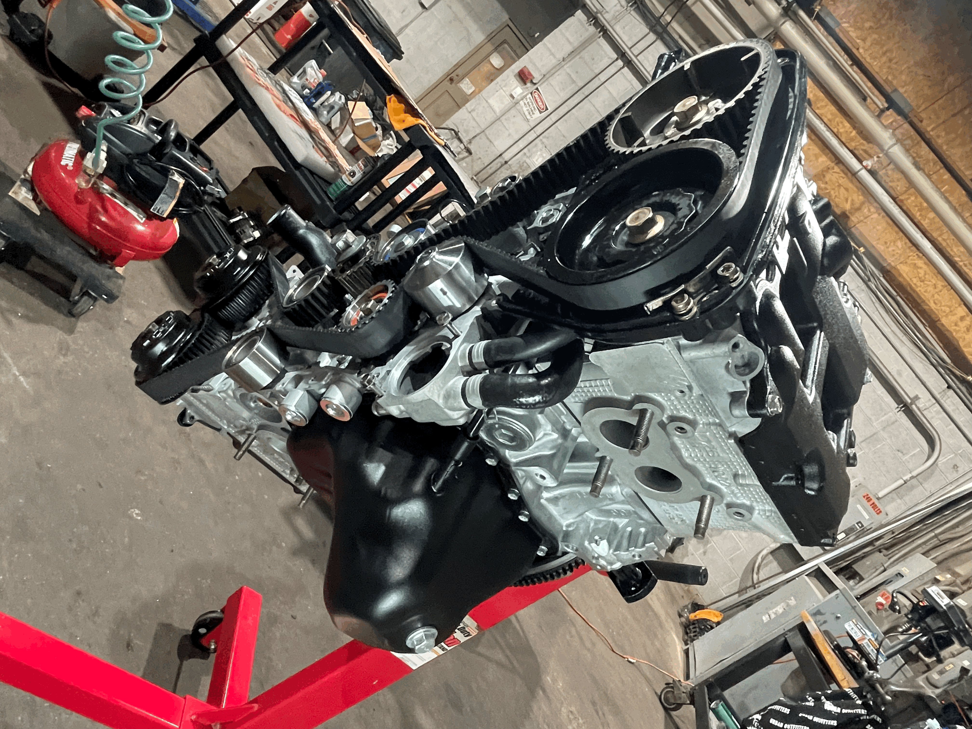 Three people sitting on a couch in a room looking at mobile devices