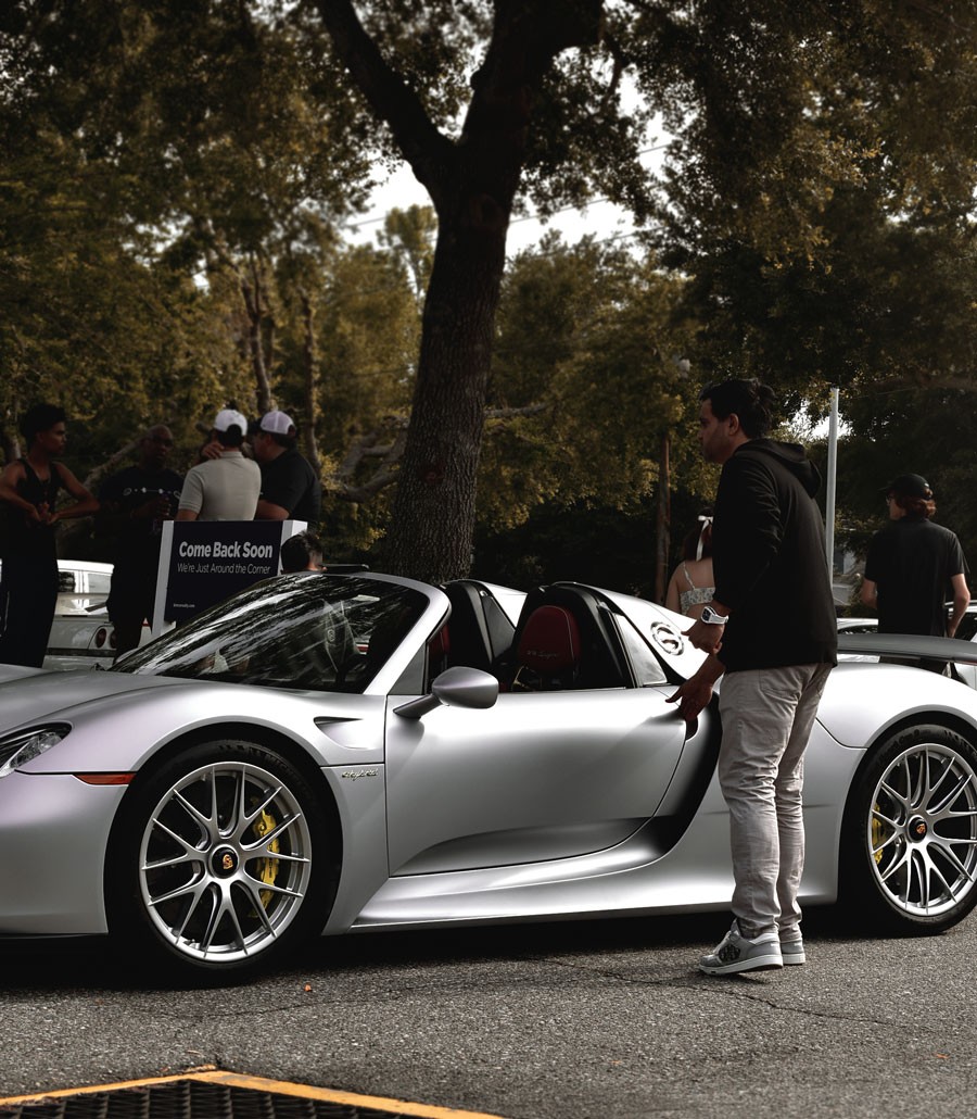 Kamran with one of his favorite vehicles, the Porsche 918 Spyder.