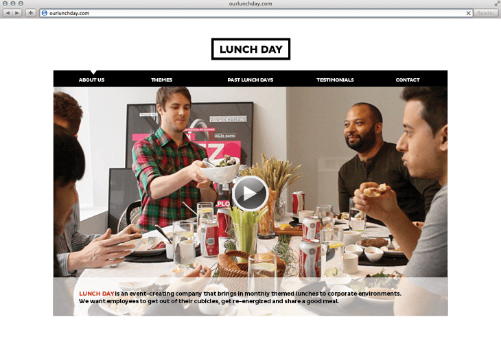 A screenshot of a website titled "LUNCH DAY" displays a video playing on a table with food and drinks. Five men are seated around the table, eating and drinking from bowls and glasses. The website's navigation bar includes "ABOUT US," "THEMES," "PAST LUNCH DAYS," "TESTIMONIALS," and "CONTACT." A text description below the video reads: "LUNCH DAY is an event-creating company that brings in monthly themed lunches to corporate environments. We want employees to get out of their cubicles, get re-energized and share a good meal."