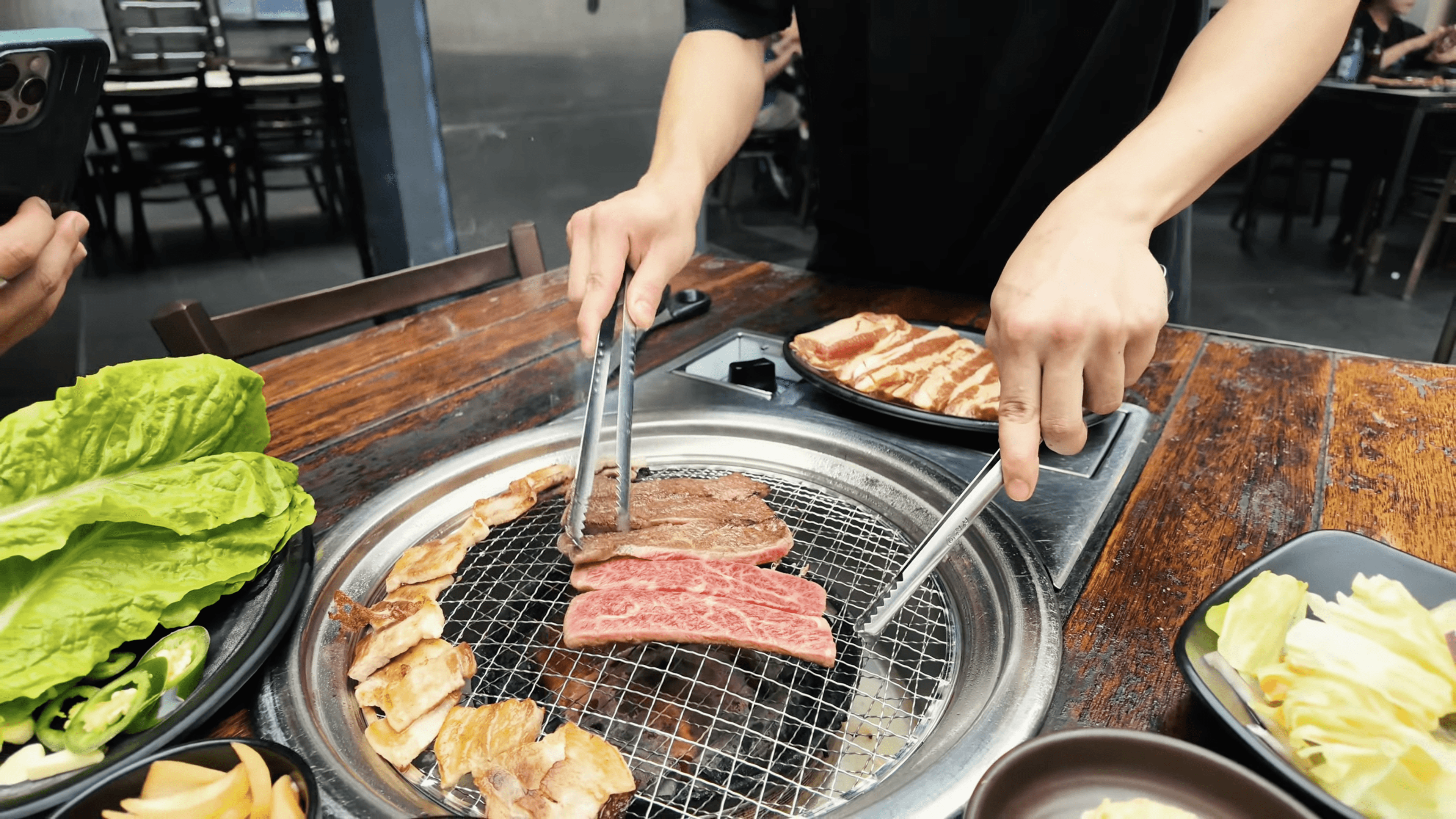 A beautiful, tropical poolside breakfast setup on a sunny morning, featuring a plate with two fried eggs over hash, a bowl of diced tomatoes, orange juice, coffee, toast, and a vase of white lilies.