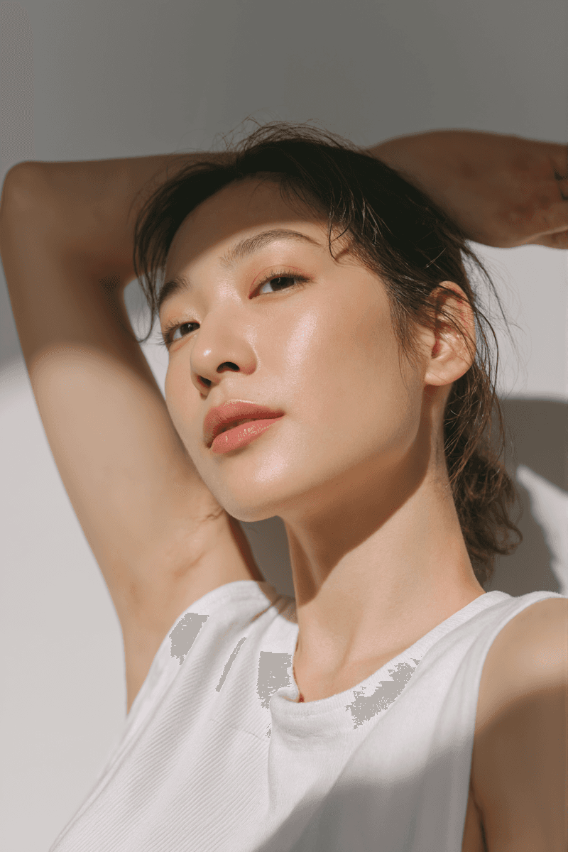 Woman in a white top in soft natural sunlight, editorial portrait
