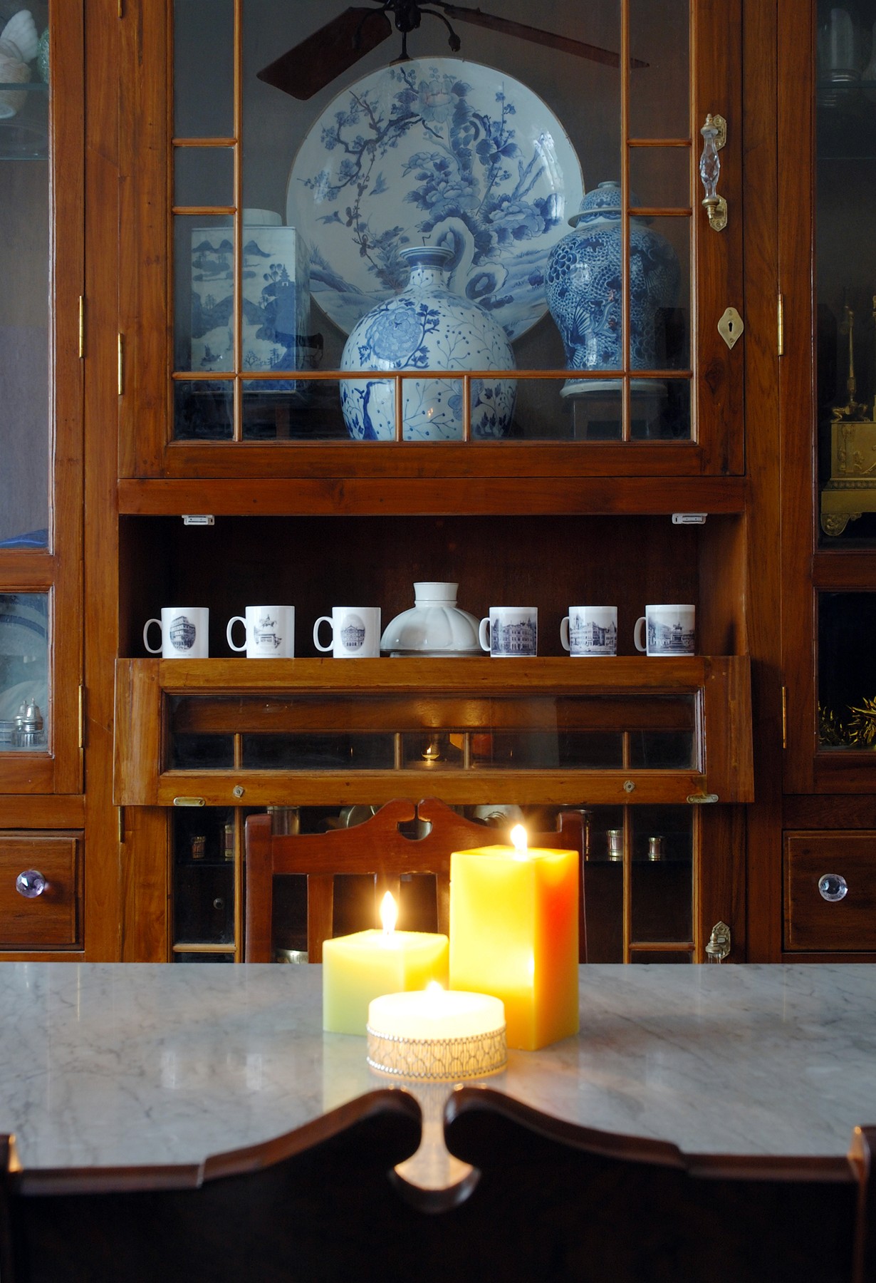 Nature-inspired preschool entrance with sculptural tree partitions and suspended green leaf ceiling panels.