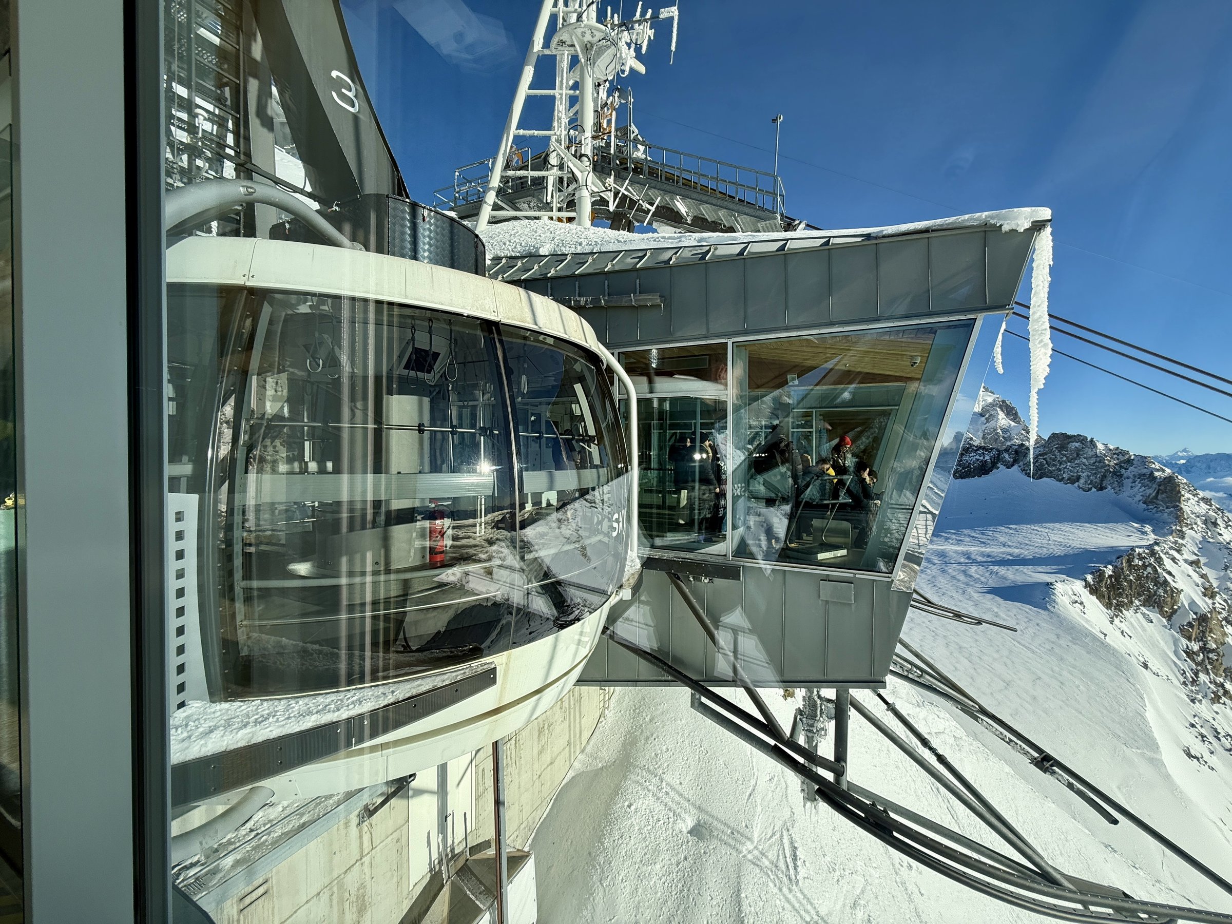 Rotating Skyway Monte Bianco cable car cabin docked at a snowy summit station near Courmayeur, Italian Alps