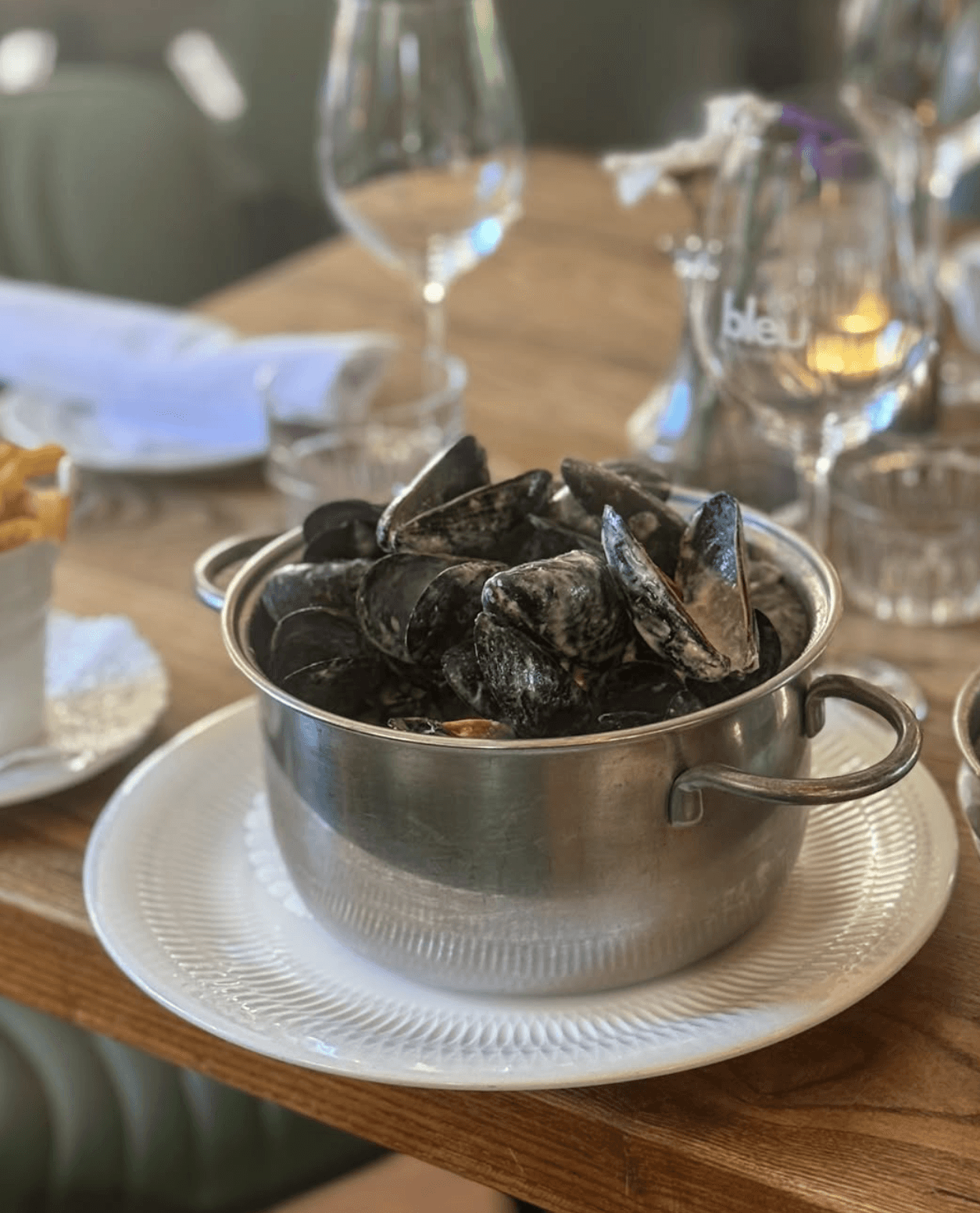 Herb-roasted chicken with baby potatoes and fresh rosemary on a dark plate.