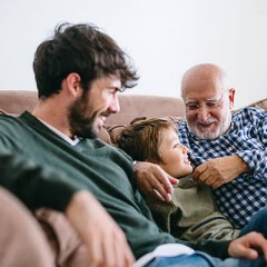 Canddid photo of a father, his son and the grandfather