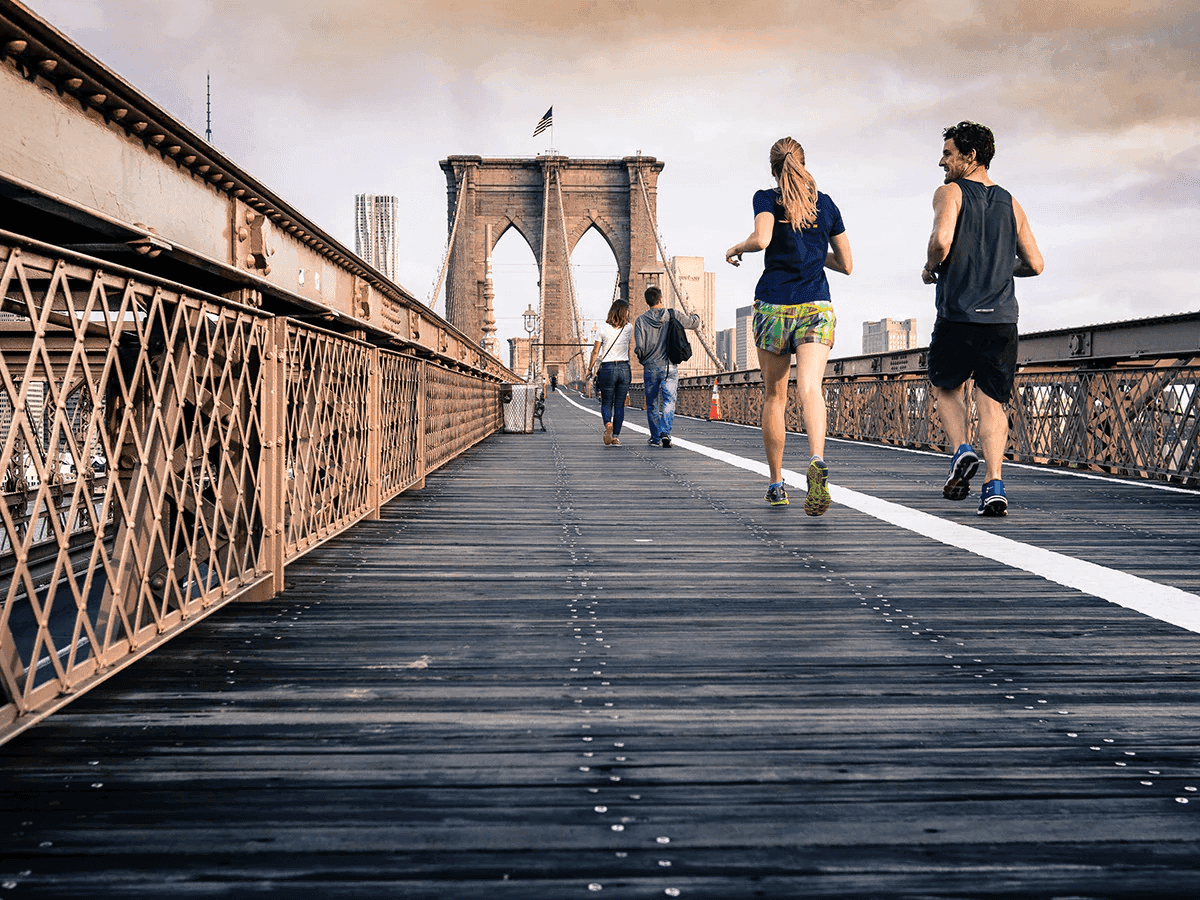 runners on Brooklyn Bridge showing endurance training
