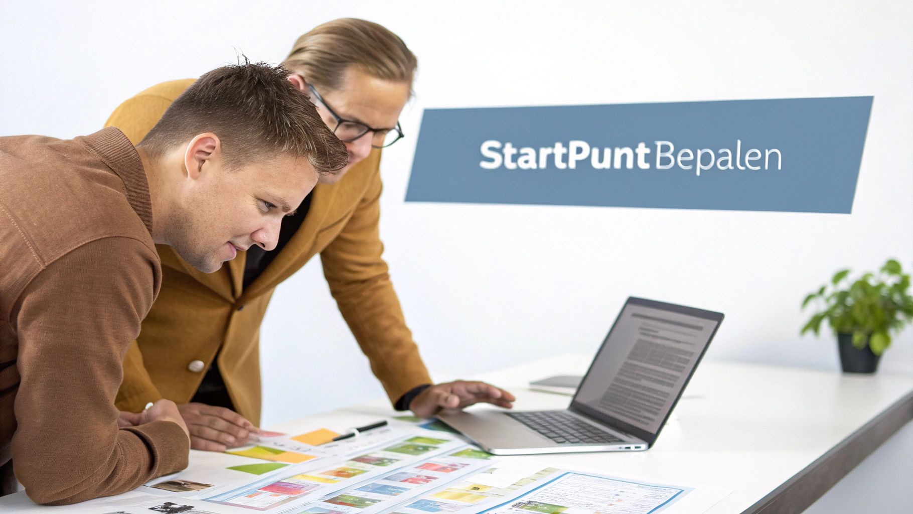 Twee professionals bij StartPunt Bepalen werken samen aan digitale transformatie met laptop en strategische documenten