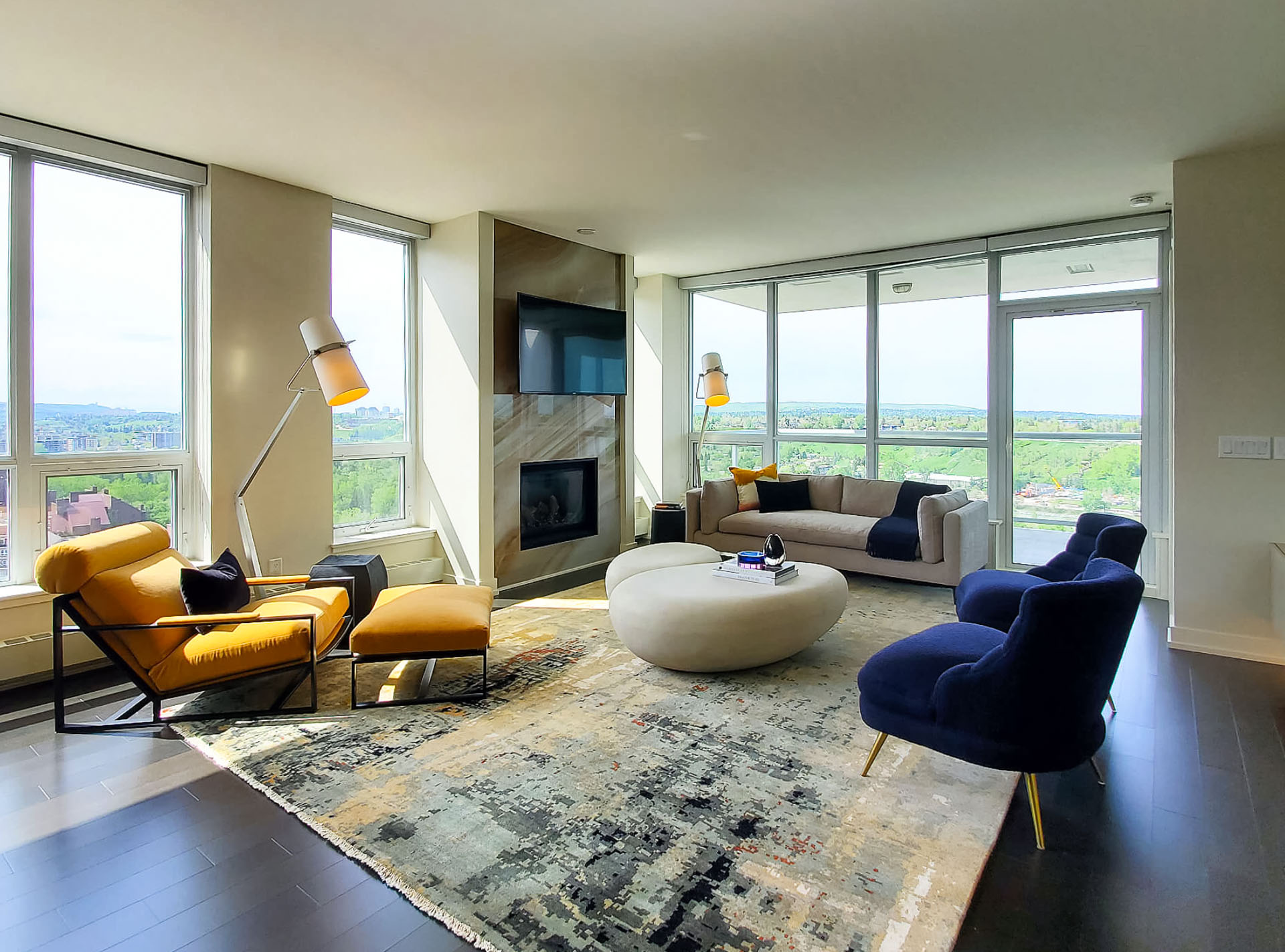 Image of Luxurious living room with modern furniture, large windows, and sleek design by KHD Homes.