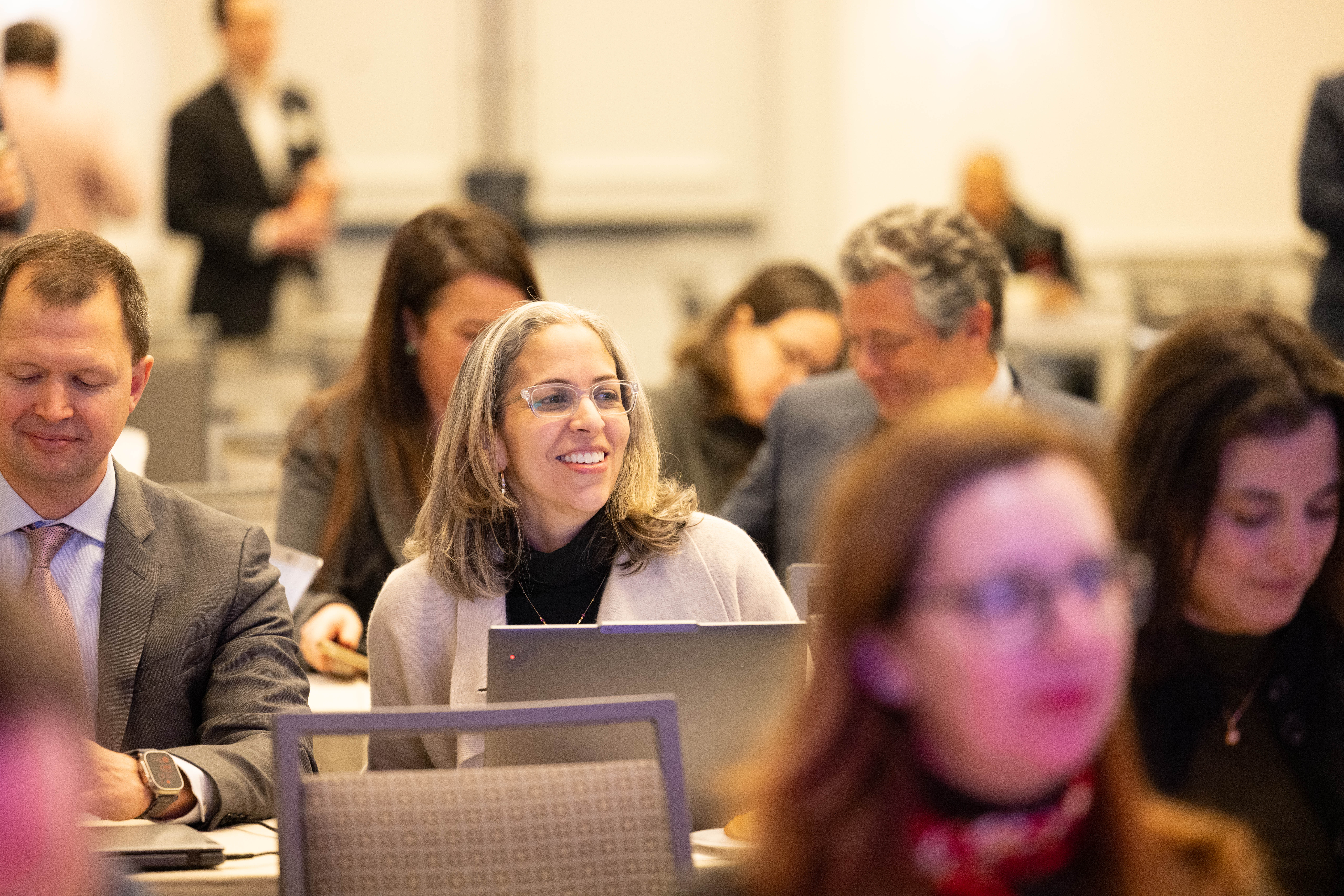 group of women in red and white dress standing on brown wooden bar during daytime
