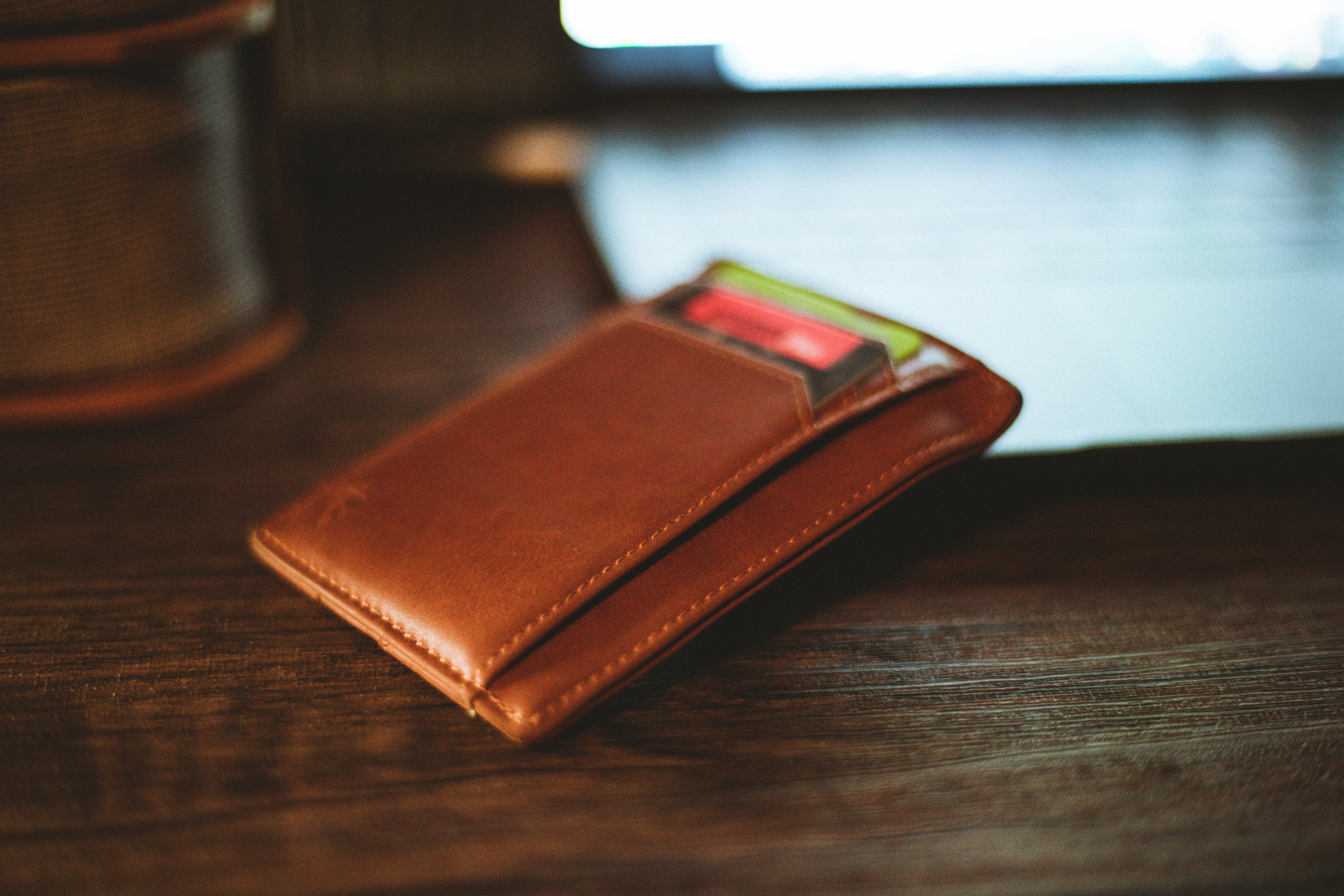 Brown leather pouch on wooden surface