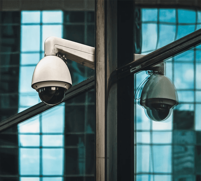 Security camera mounted on a building, representing surveillance systems that may be missing or malfunctioning in negligent security cases
